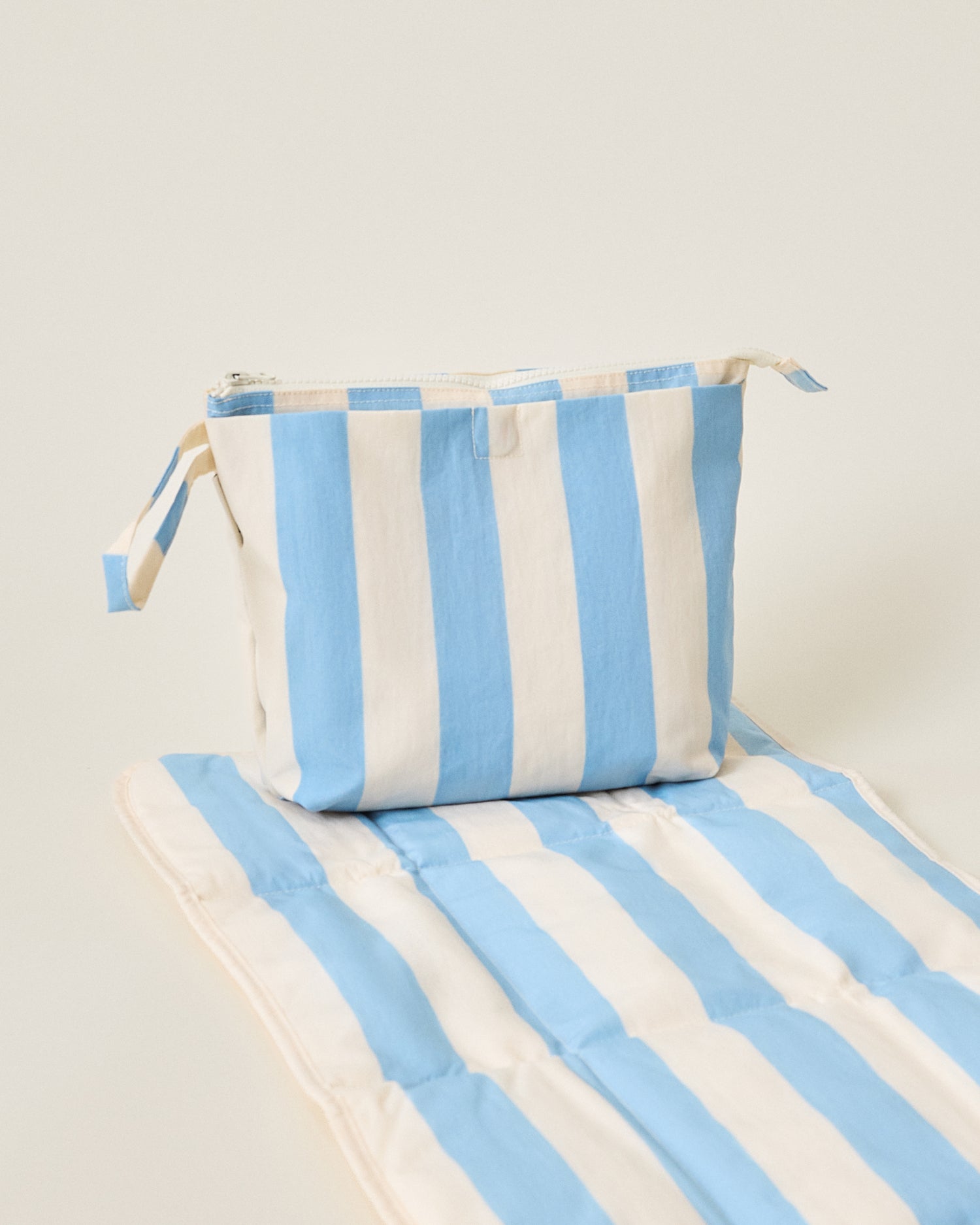 Quick Change Kit Bag and mat in Blue Wide Stripe pattern on a beige background