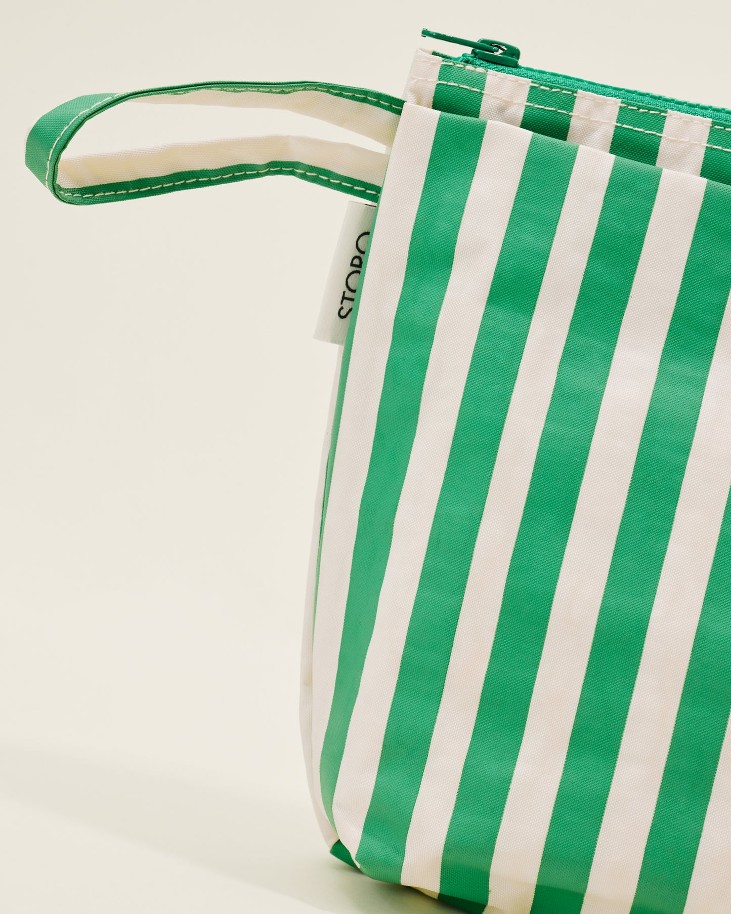 Close up of Quick Change Kit Bag in Green Stripe print