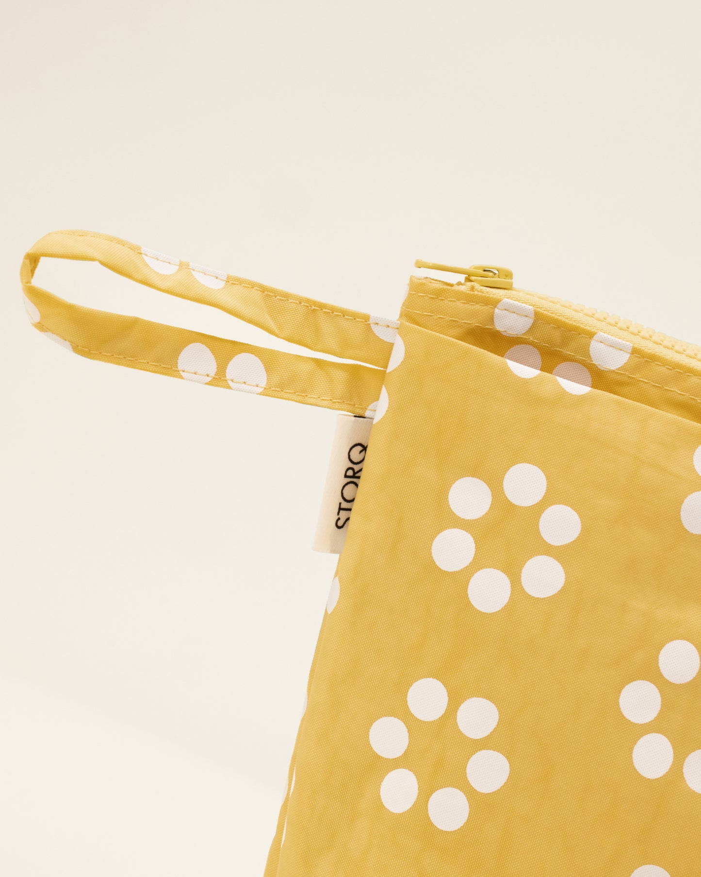 Close up of the Quick Change Kit Bag in Sunshine Dots print, on a neutral background