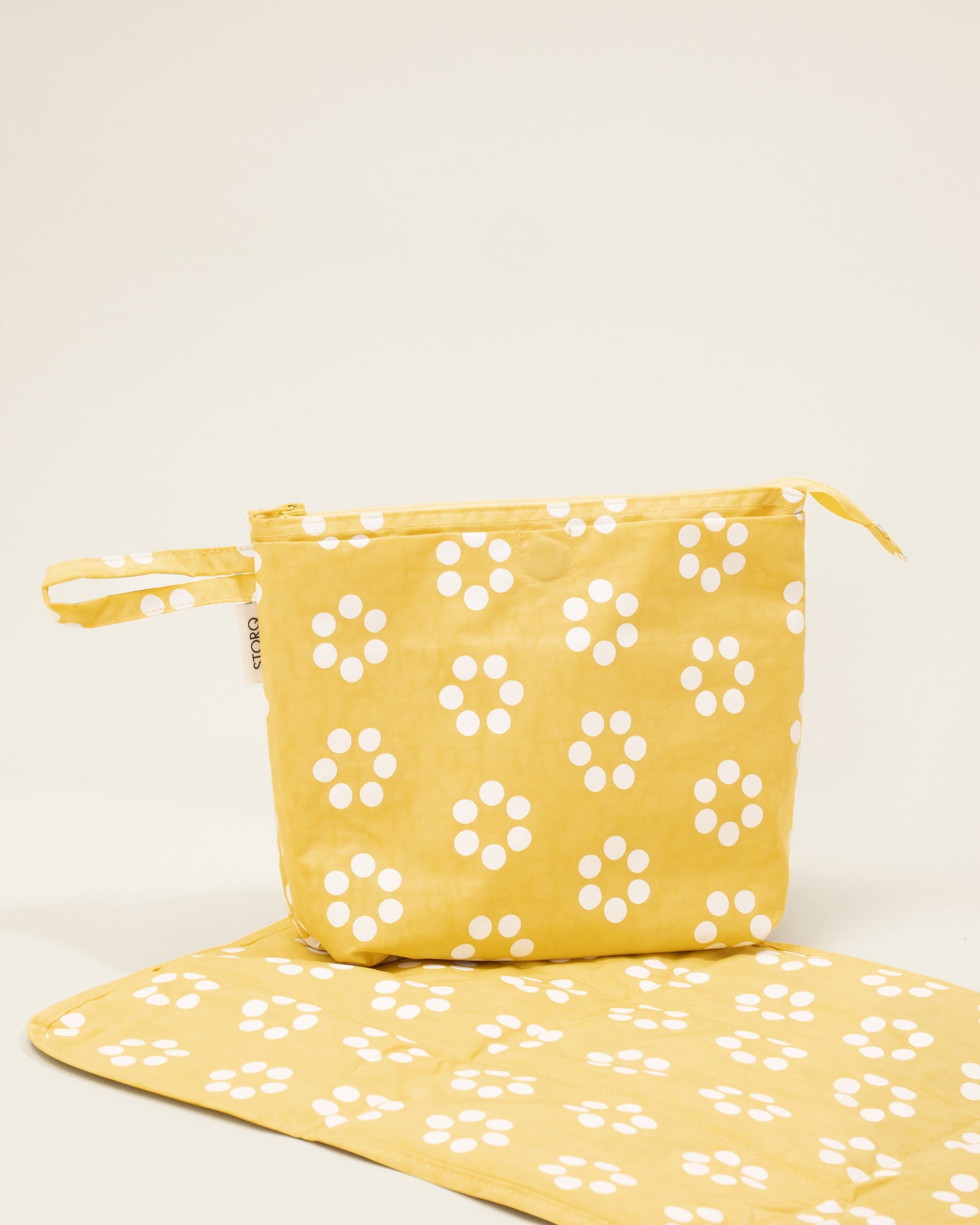 Quick Change Kit Bag in Sunshine Dots print, on a neutral background with the changing pad open