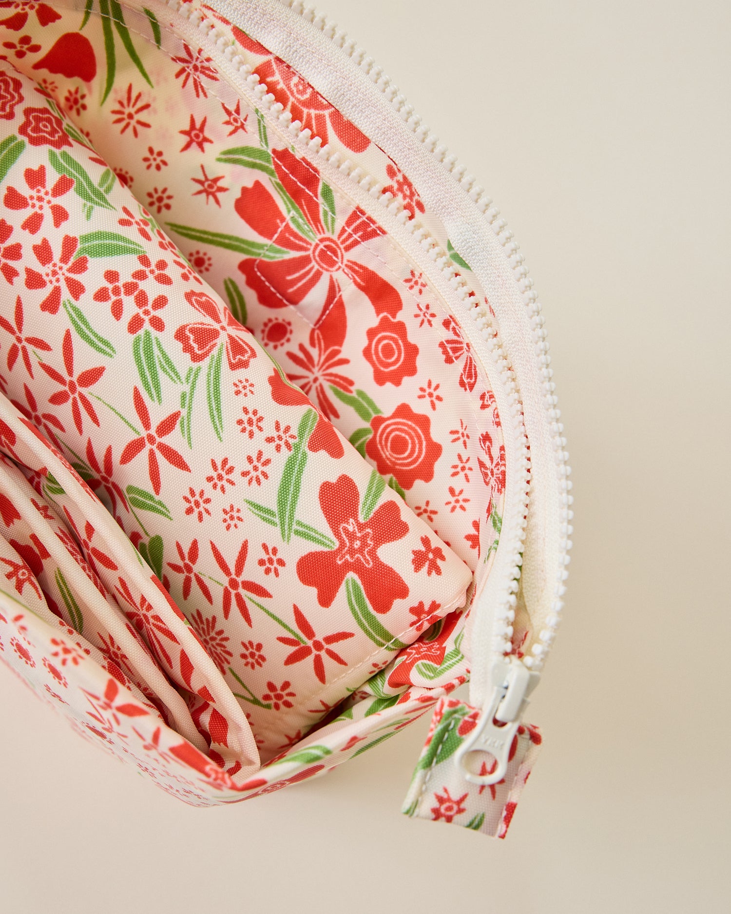 Close up of Quick Change Kit Bag in Superbloom on a beige background