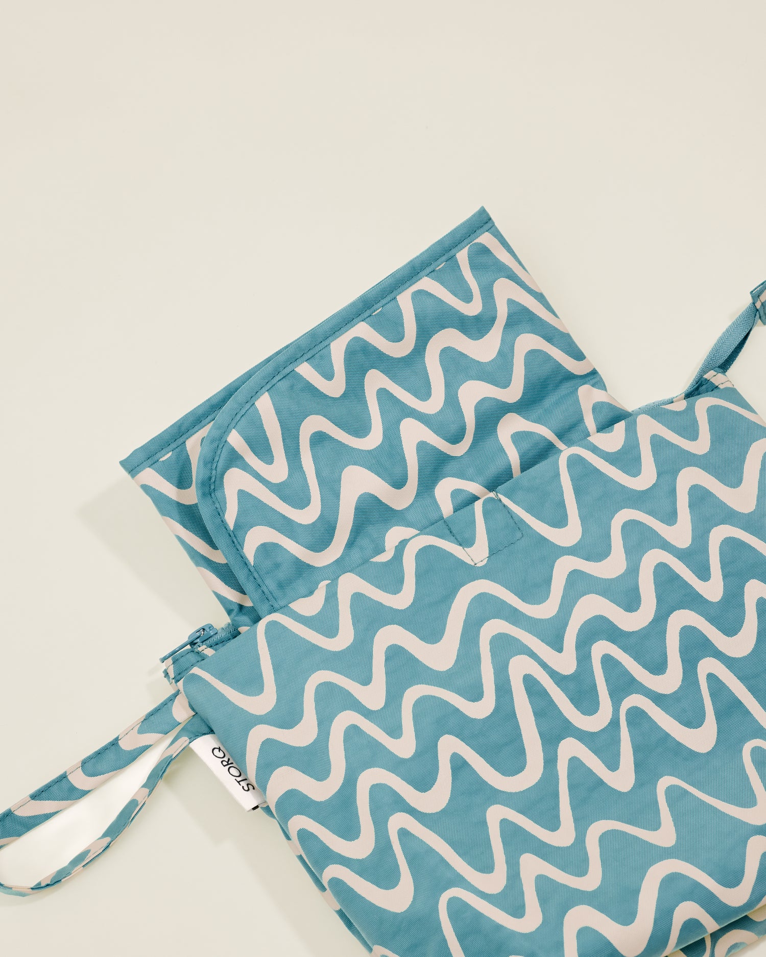 Quick Change Kit Bag in Blue Waves print, showing the folded changing pad inside
