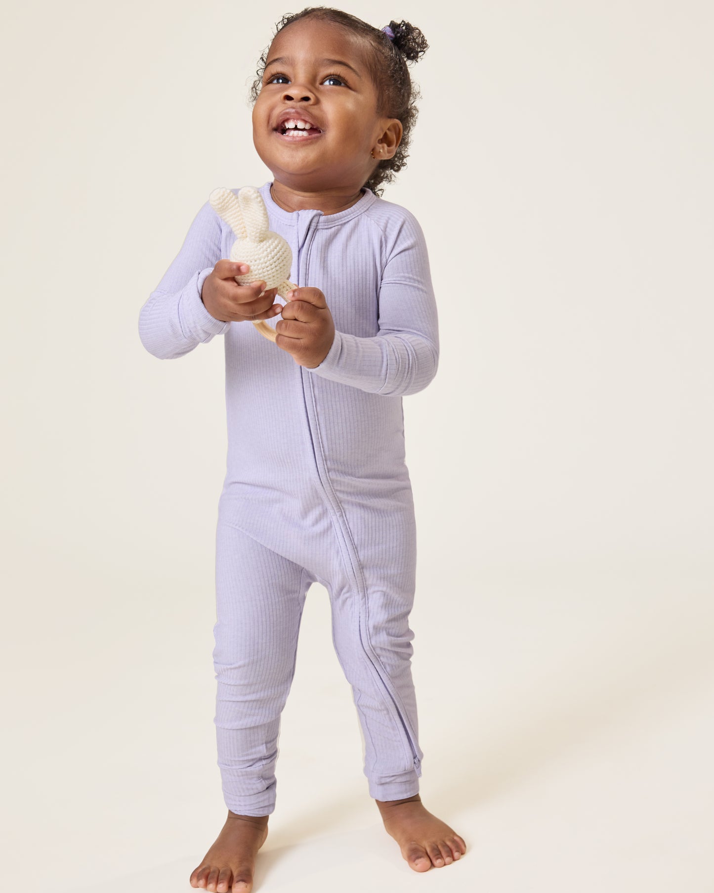 Baby wearing the Ribbed Bamboo Baby Pajama in Lilac Heather@model_info:Harper is wearing 18-24 months.