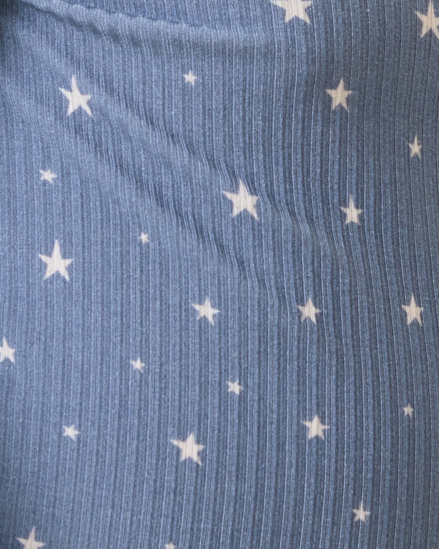 Close up of Baby wearing the Ribbed Bamboo Baby Two-Piece Pajama Set in Blue Stars