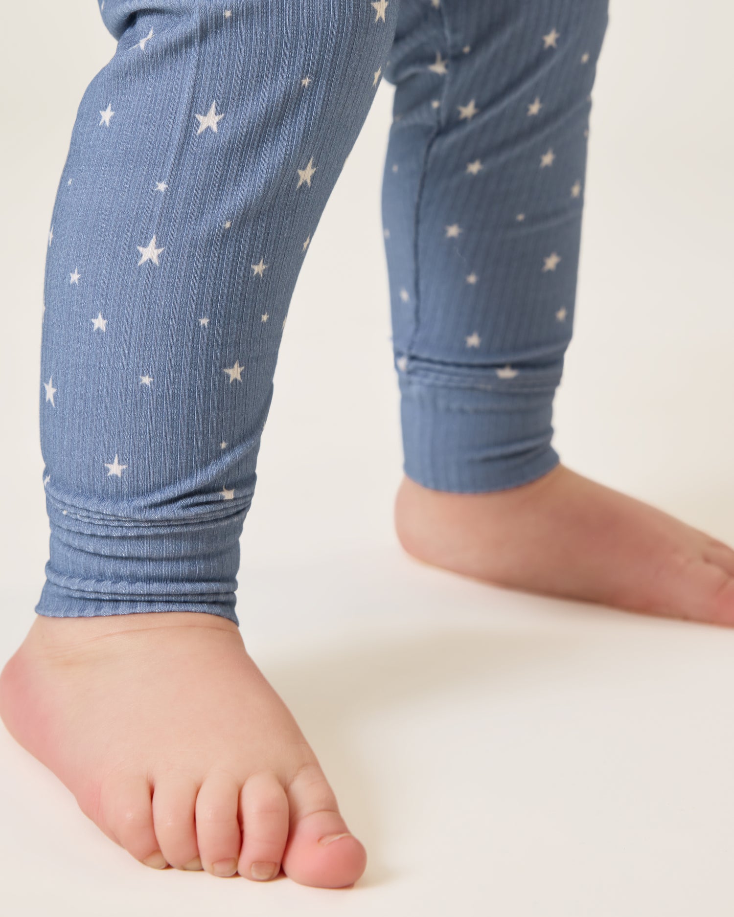 Close up of Baby wearing the Ribbed Bamboo Baby Two-Piece Pajama Set in Blue Stars