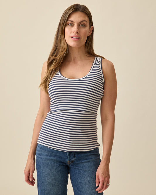 Model wearing Ribbed Bamboo Scoop Neck Nursing Tank in Navy White Stripe on a beige background @model_info:Brittany is wearing a Small.