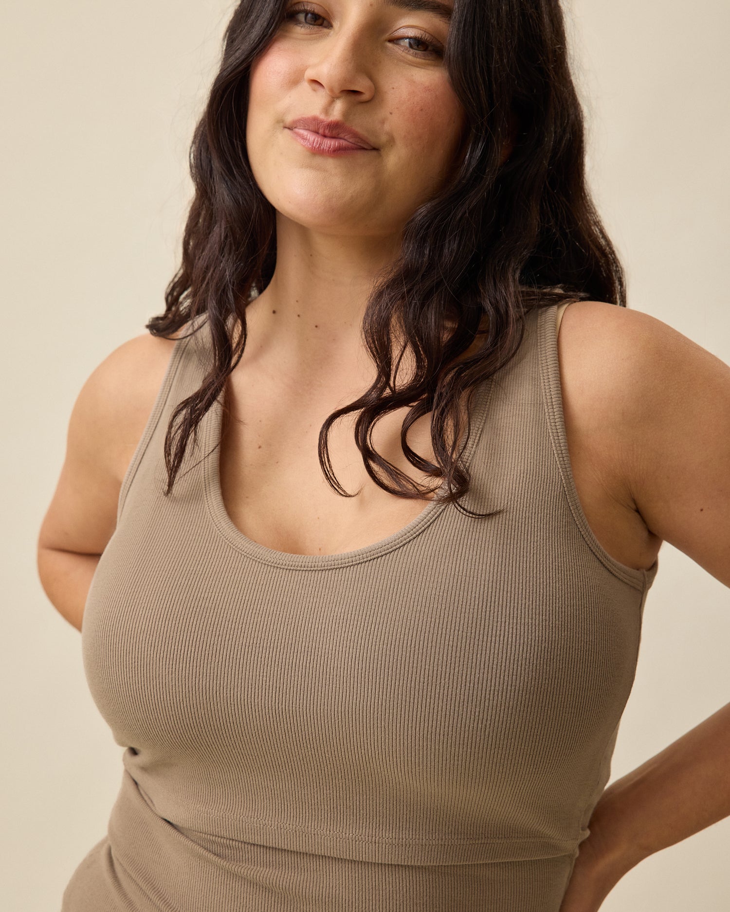 Model wearing Ribbed Bamboo Scoop Neck Nursing Tank in Taupe on a beige background