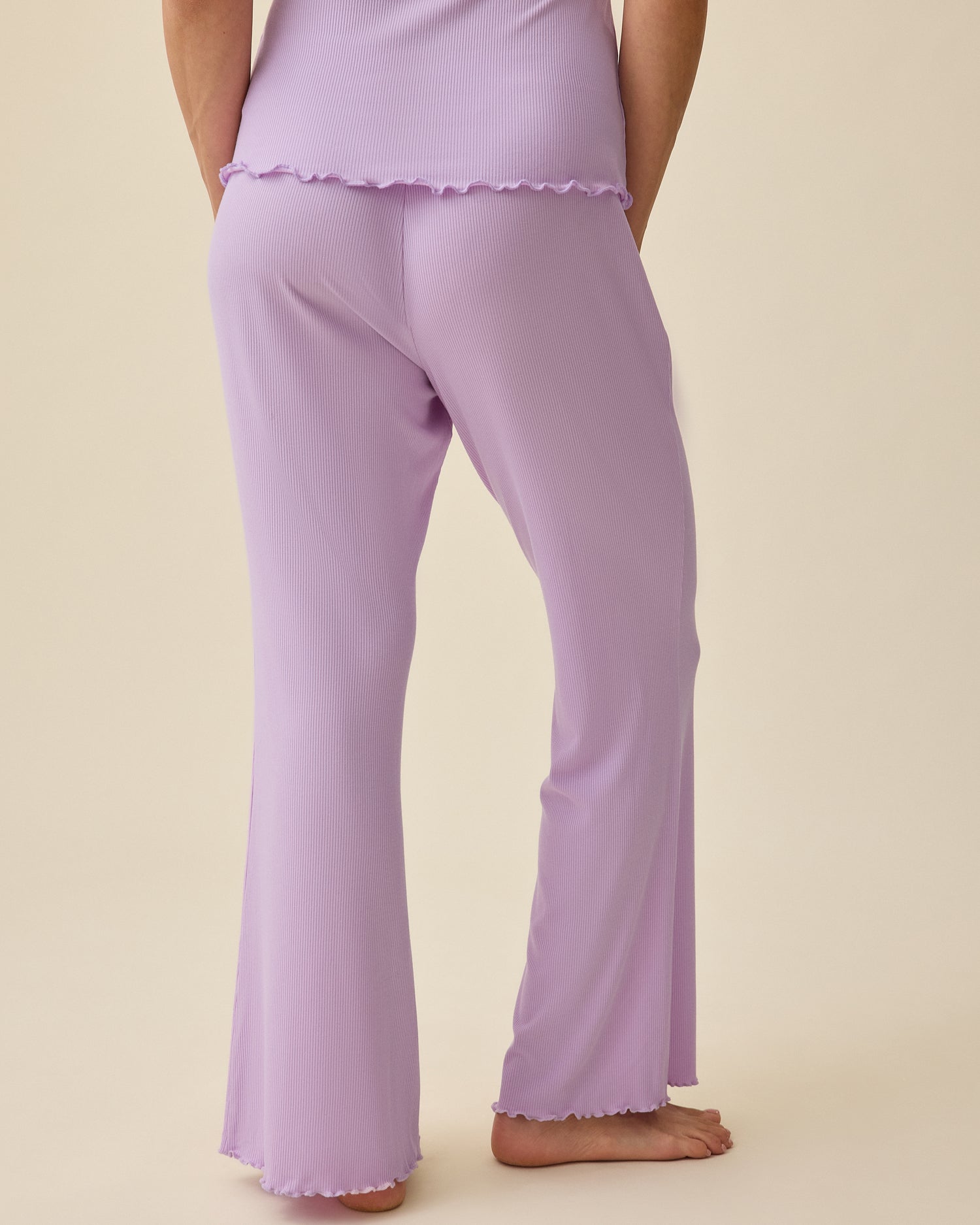 Back view of model wearing Ribbed Modal Nursing Cami and Ribbed Modal Lounge Pant in Lavender on a beige background.