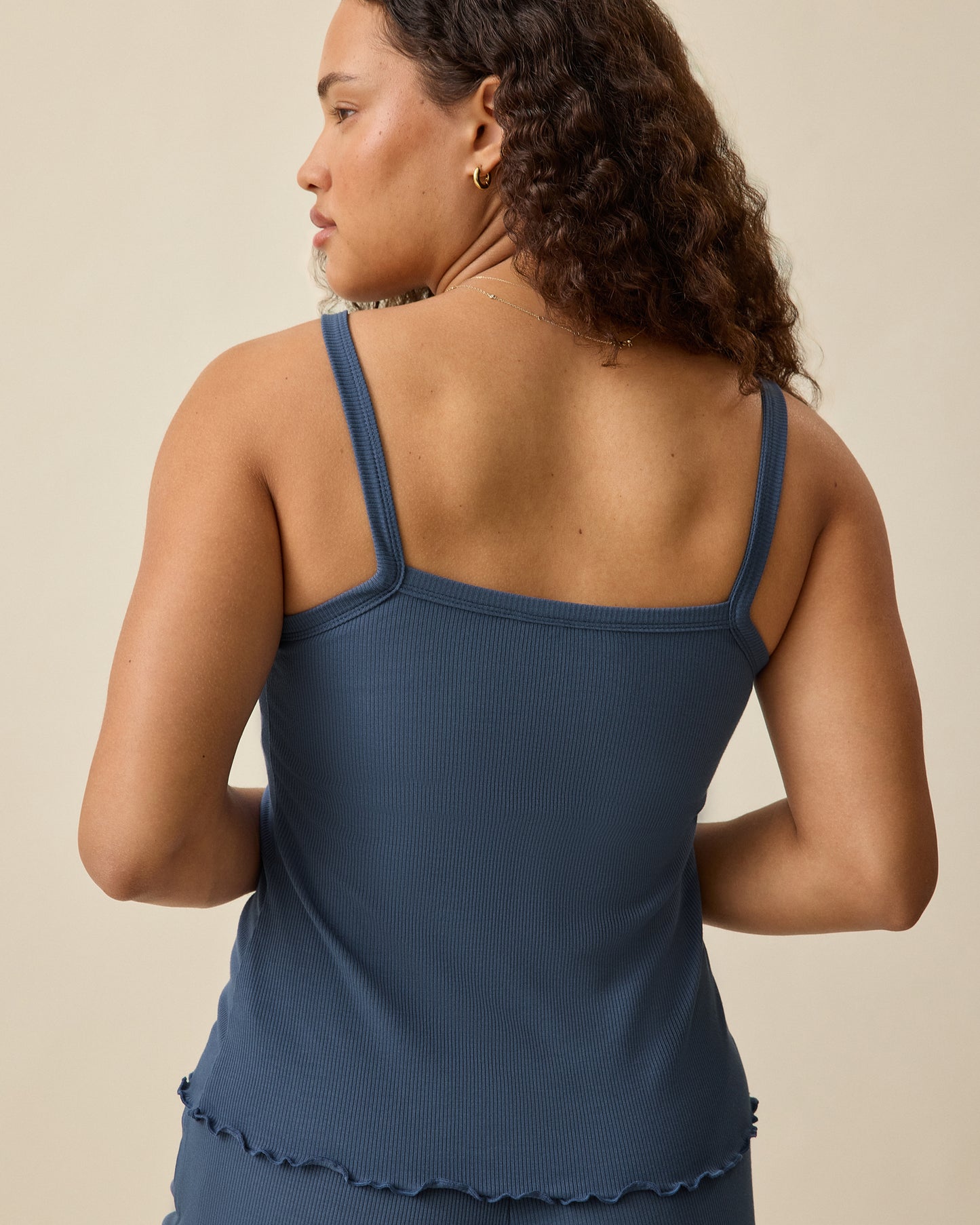 Back view of the Ribbed Modal Nursing Cami and Lounge Pant in Light Navy on a beige background. 