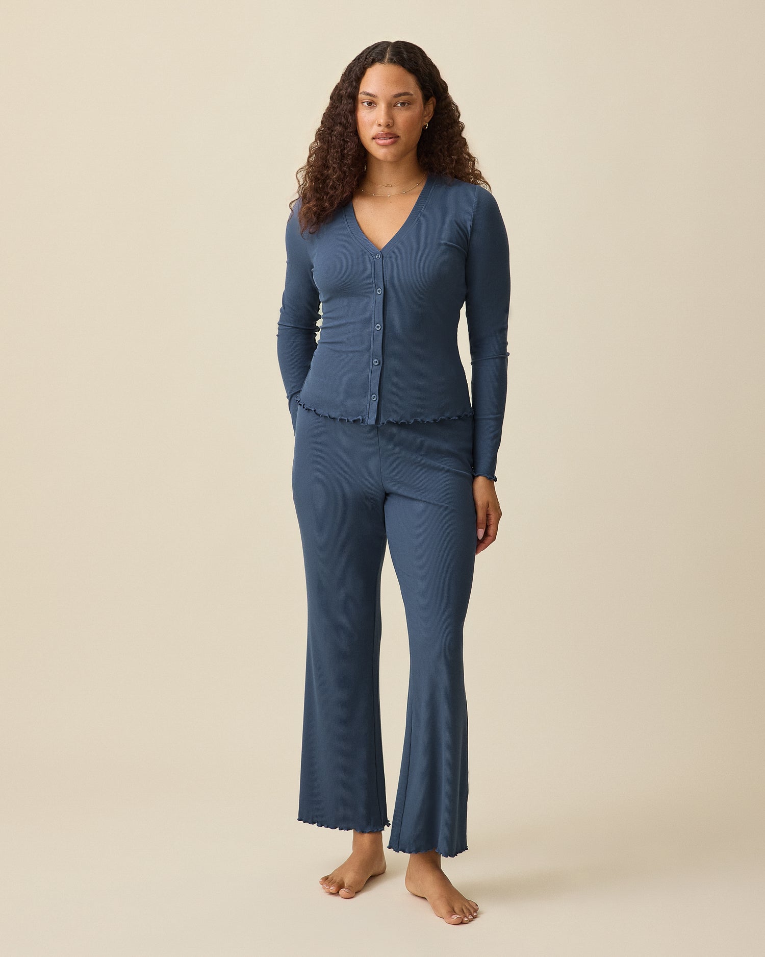 Model is wearing Ribbed Modal Separates Set in Light Navy on a beige background. Includes matching Cami, Cardigan and Lounge pant.