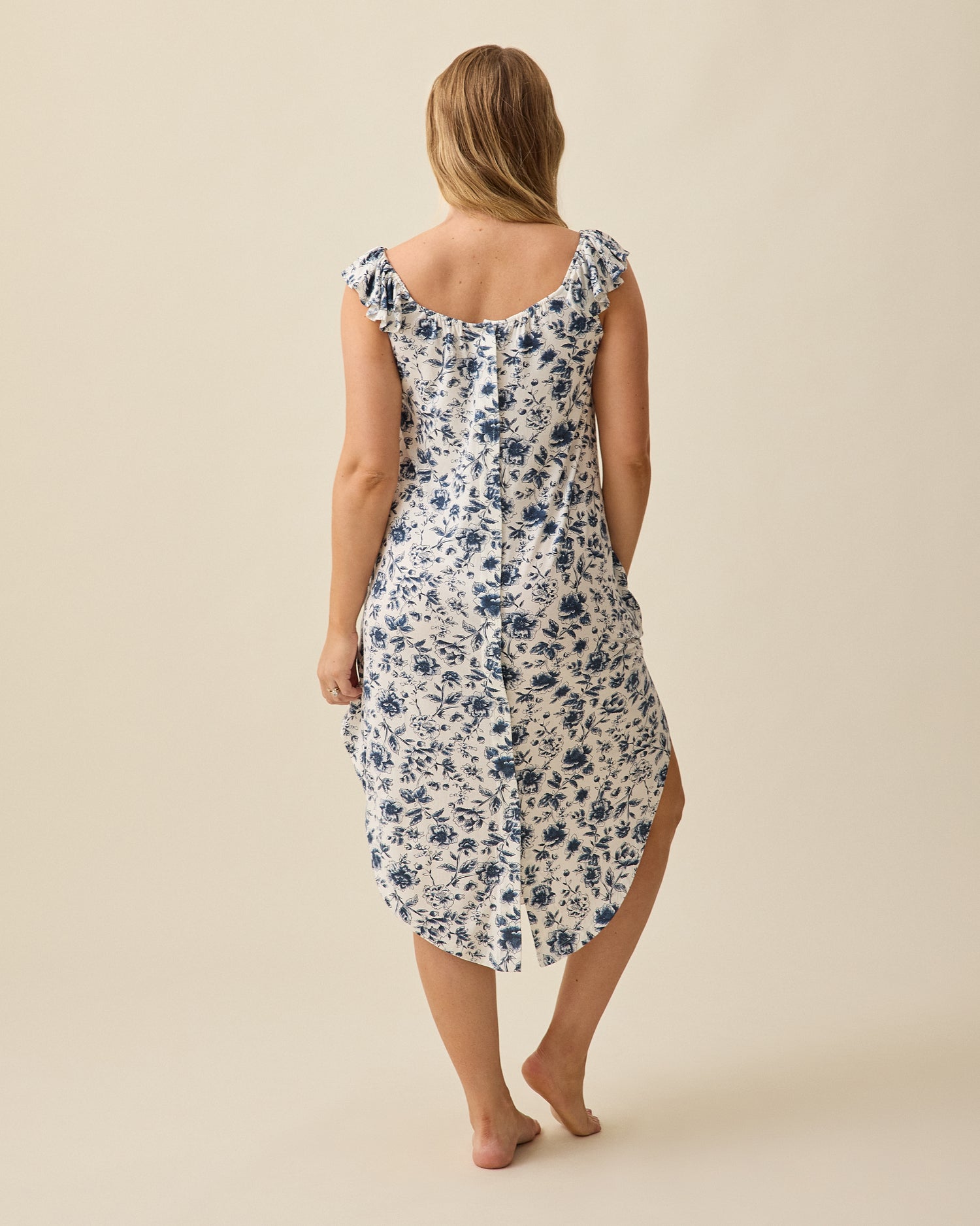 Back view of Ruffle Strap Labor & Delivery Gown in Navy Toile on a beige background