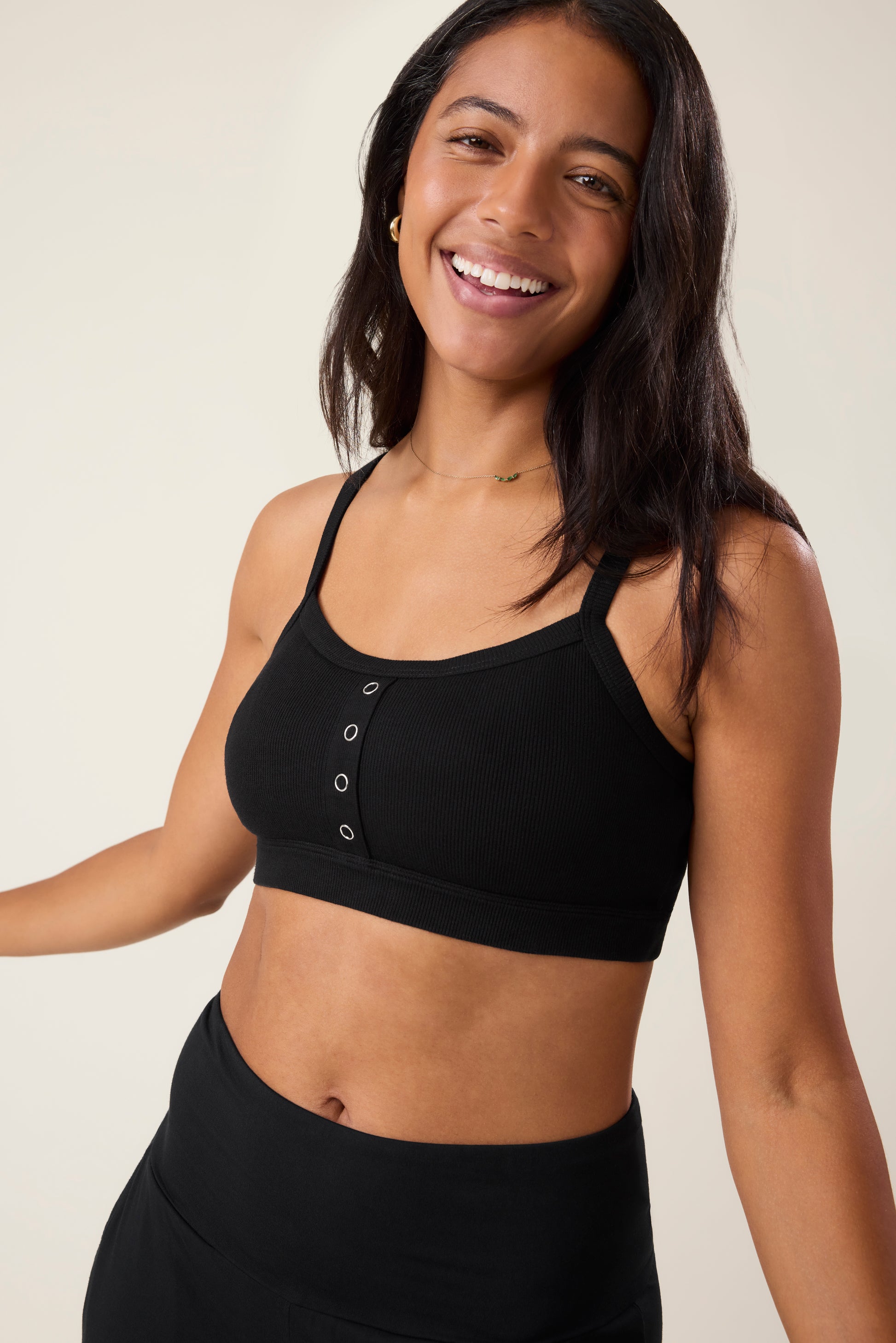 Woman wearing the Ribbed Bamboo Pumping Bralette in Black@model_info:Nemesis is wearing a Medium.