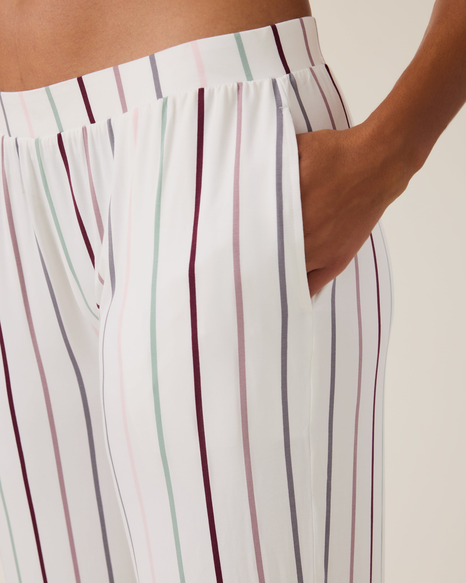 Closeup of the Clea Bamboo Long Sleeve Pajama Set bottoms in Classic Stripe, with hand in pocket
