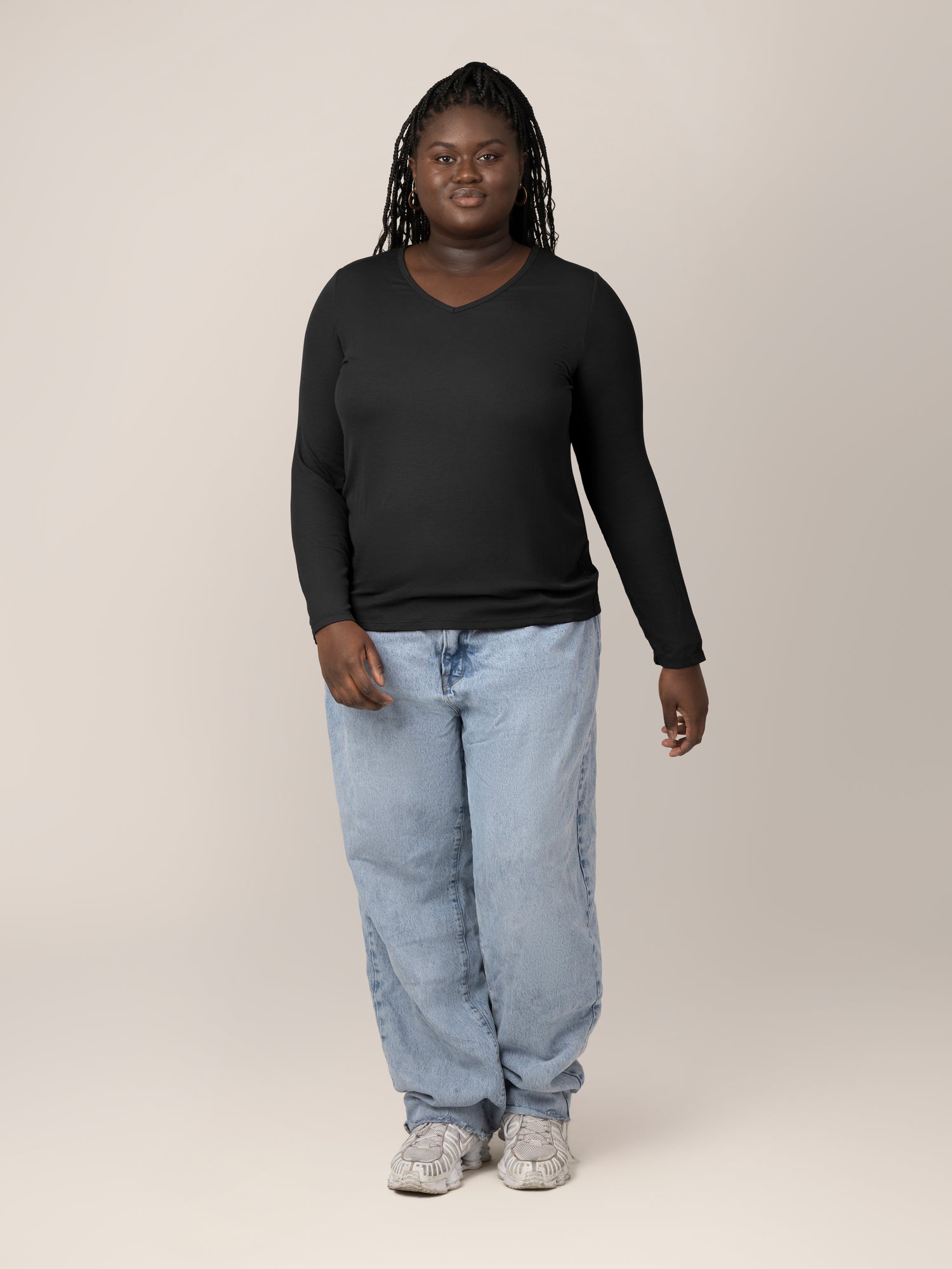 Front full body view of model wearing the Ribbed Bamboo Maternity & Nursing Long Sleeve T-shirt in Black, paired with jeans and tennis shoes