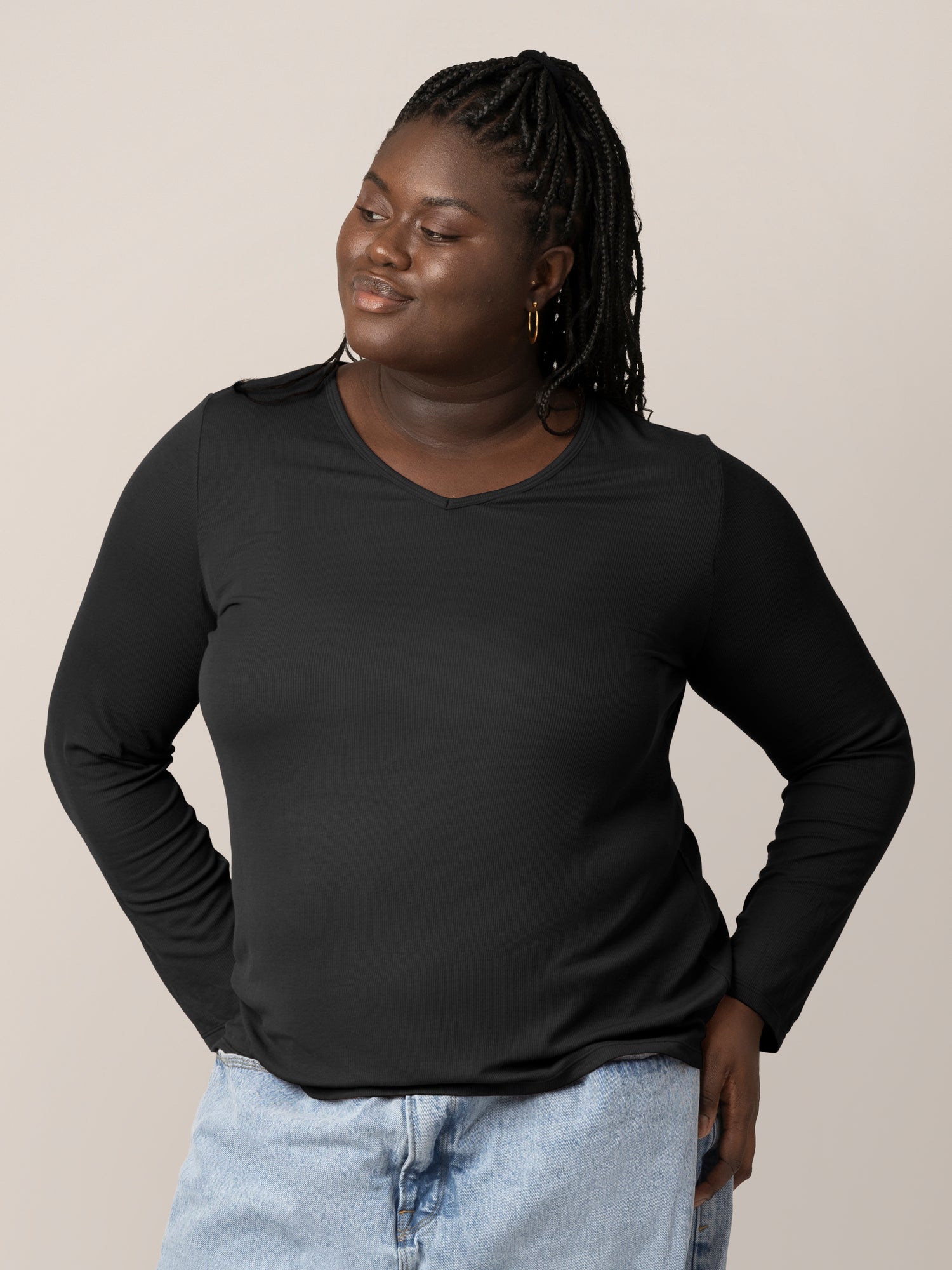 Front view of model wearing the Ribbed Bamboo Maternity & Nursing Long Sleeve T-shirt in Black, with hands on hips @model_info:Bintou is wearing an X-Large.