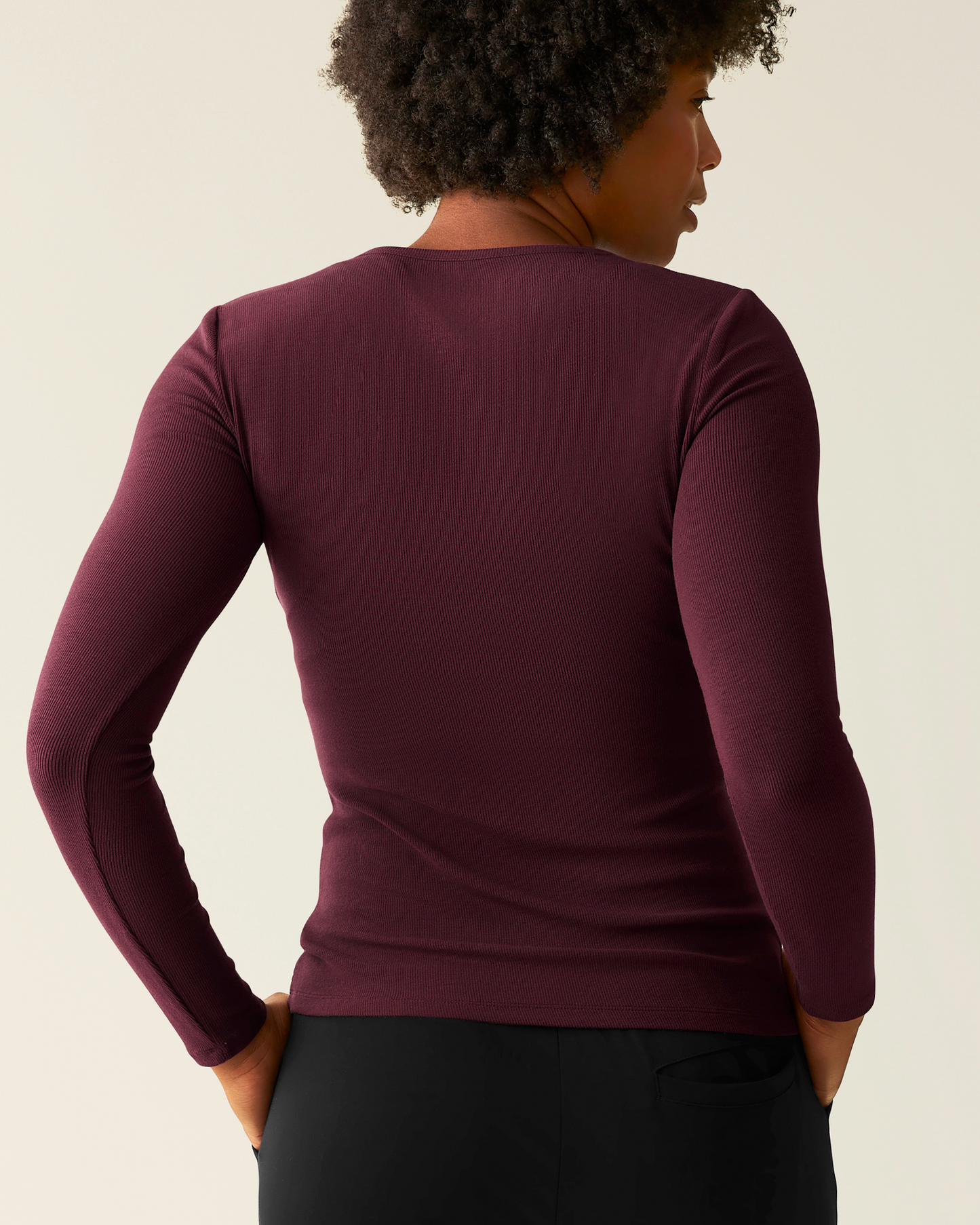 Woman wearing the Ribbed Bamboo Long Sleeve Nursing T-shirt in Deep Burgundy, showing back of top