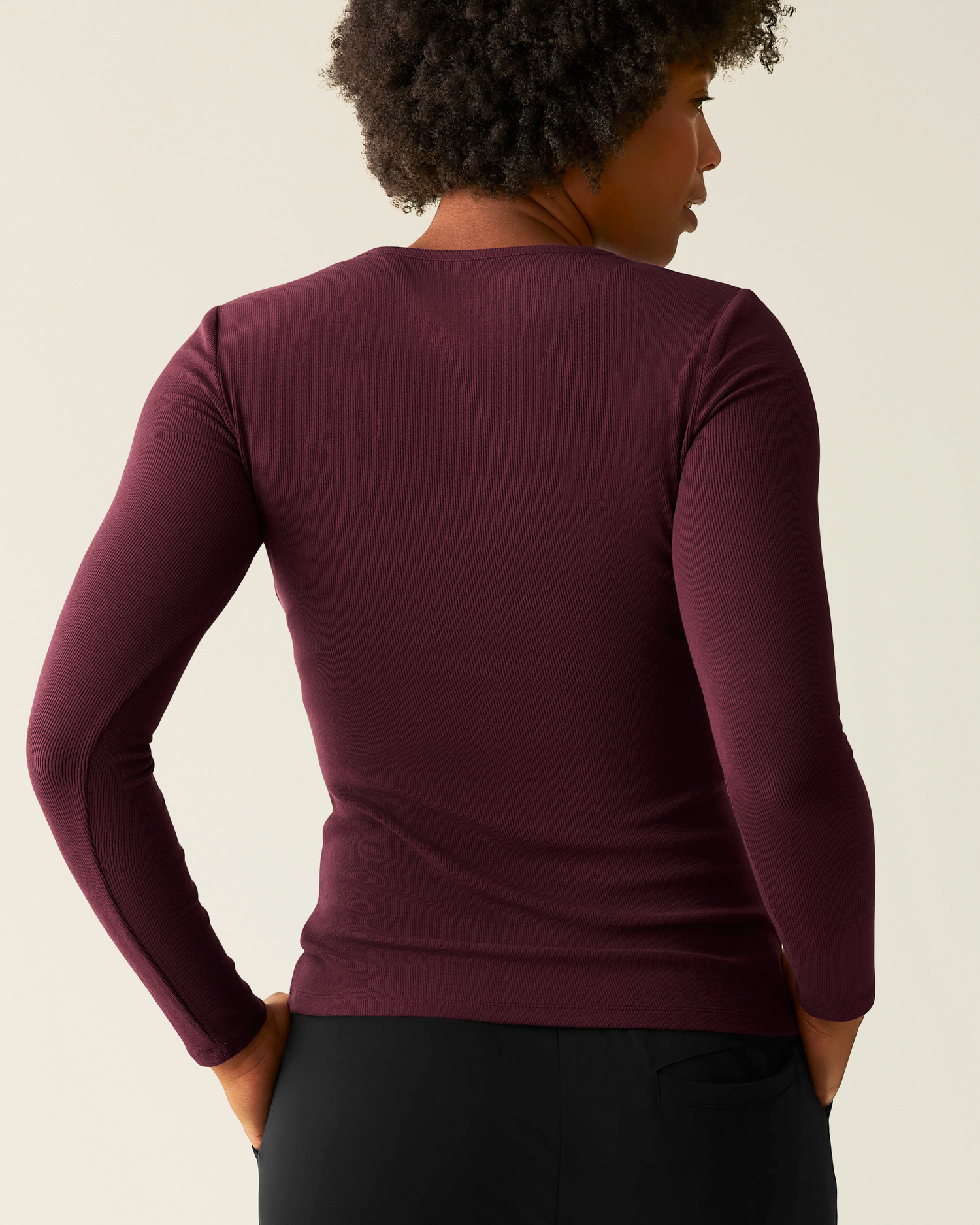 Woman wearing the Ribbed Bamboo Long Sleeve Nursing T-shirt in Deep Burgundy, showing back of top