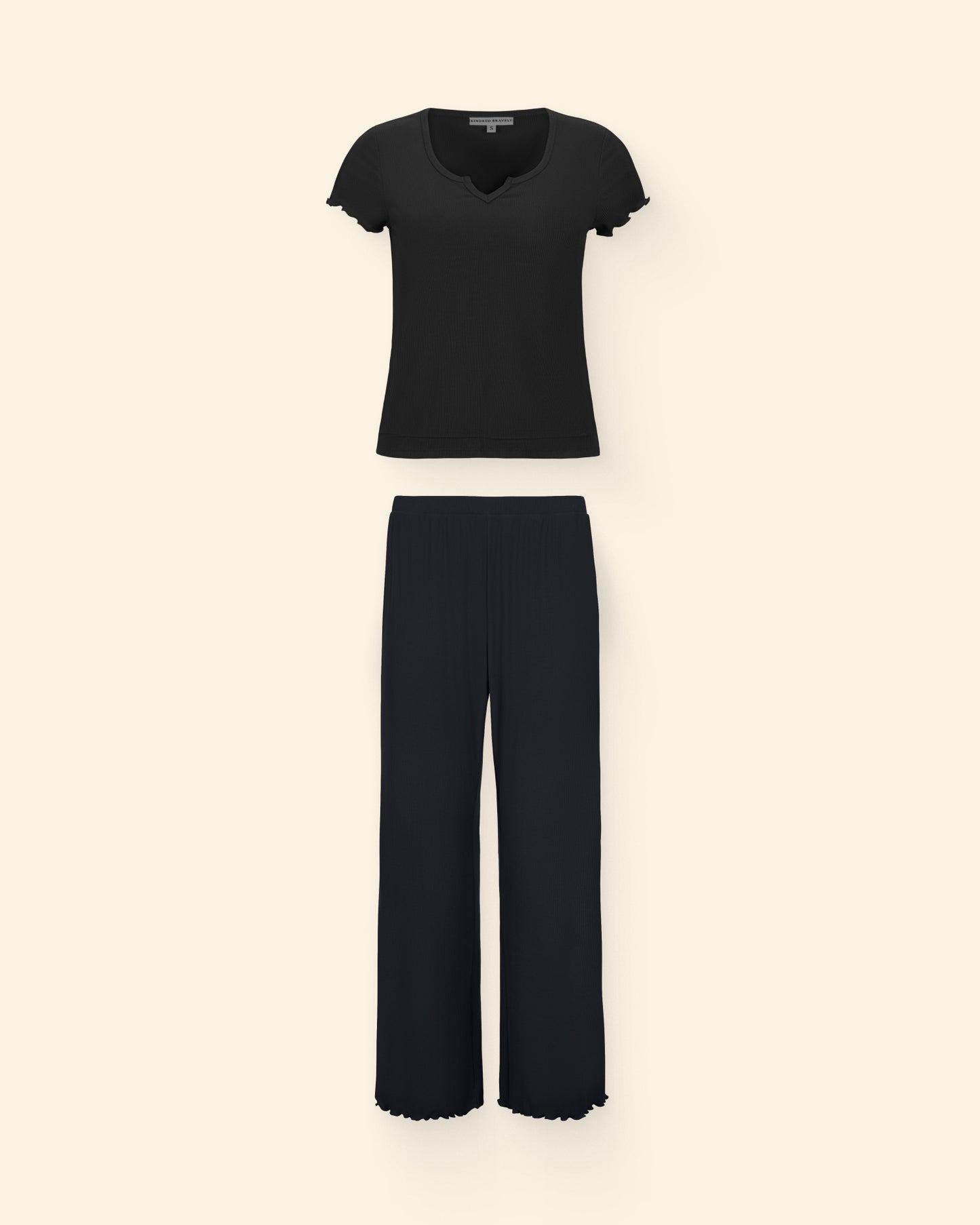 Ribbed Modal Notched Nursing T-Shirt in Black and Ribbed Modal Lounge Pant in Black on a beige background.