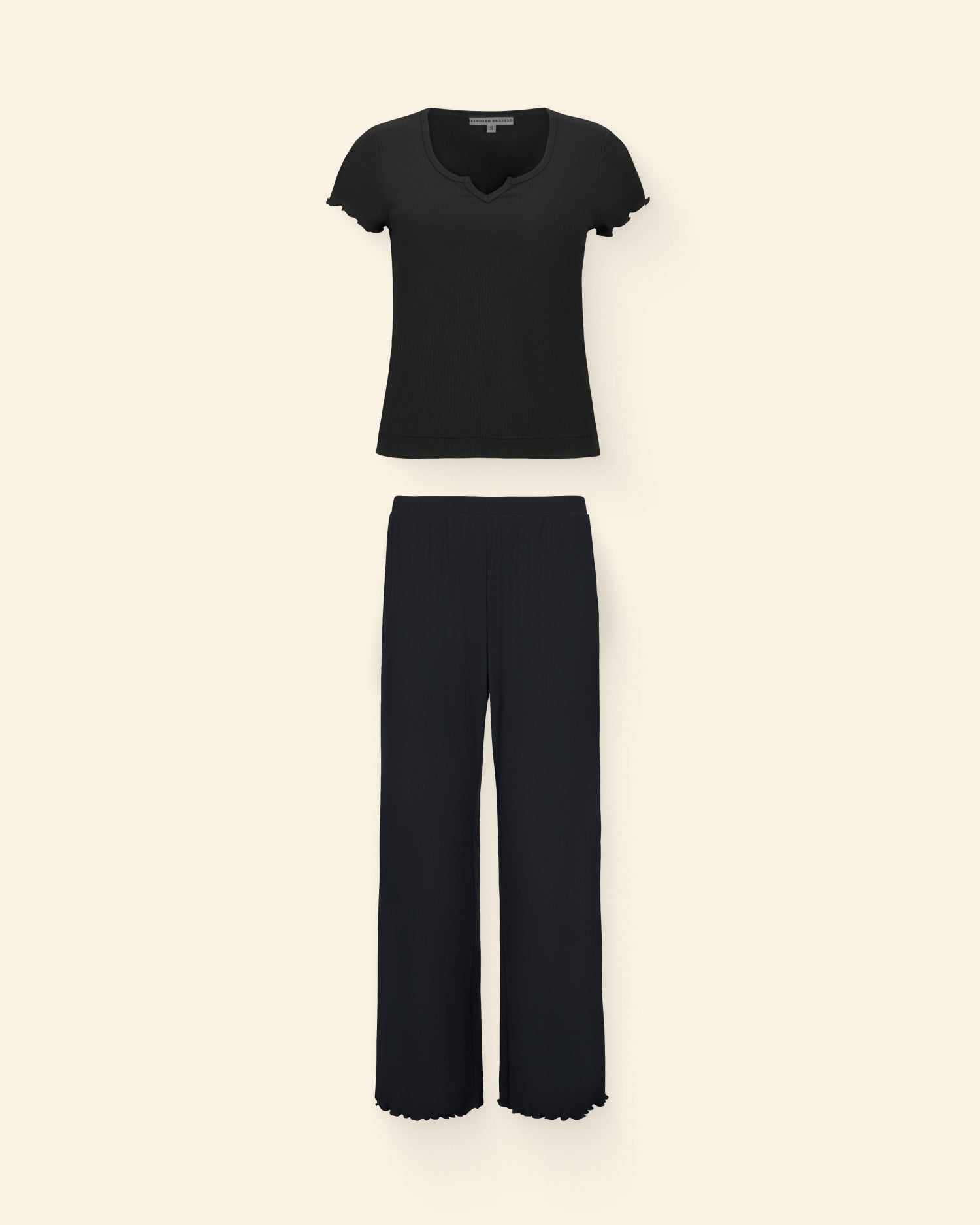 Ribbed Modal Notched Nursing T-Shirt in Black and Ribbed Modal Lounge Pant in Black on a beige background.