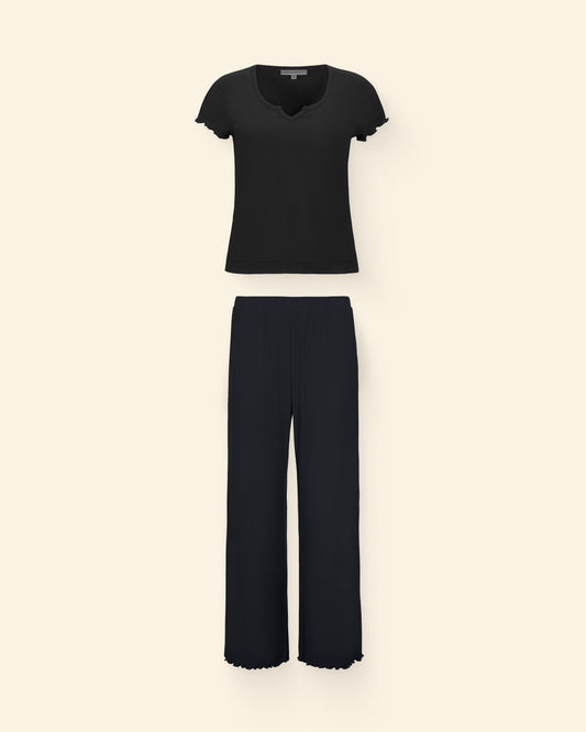 Ribbed Modal Notched Nursing T-Shirt in Black and Ribbed Modal Lounge Pant in Black on a beige background.