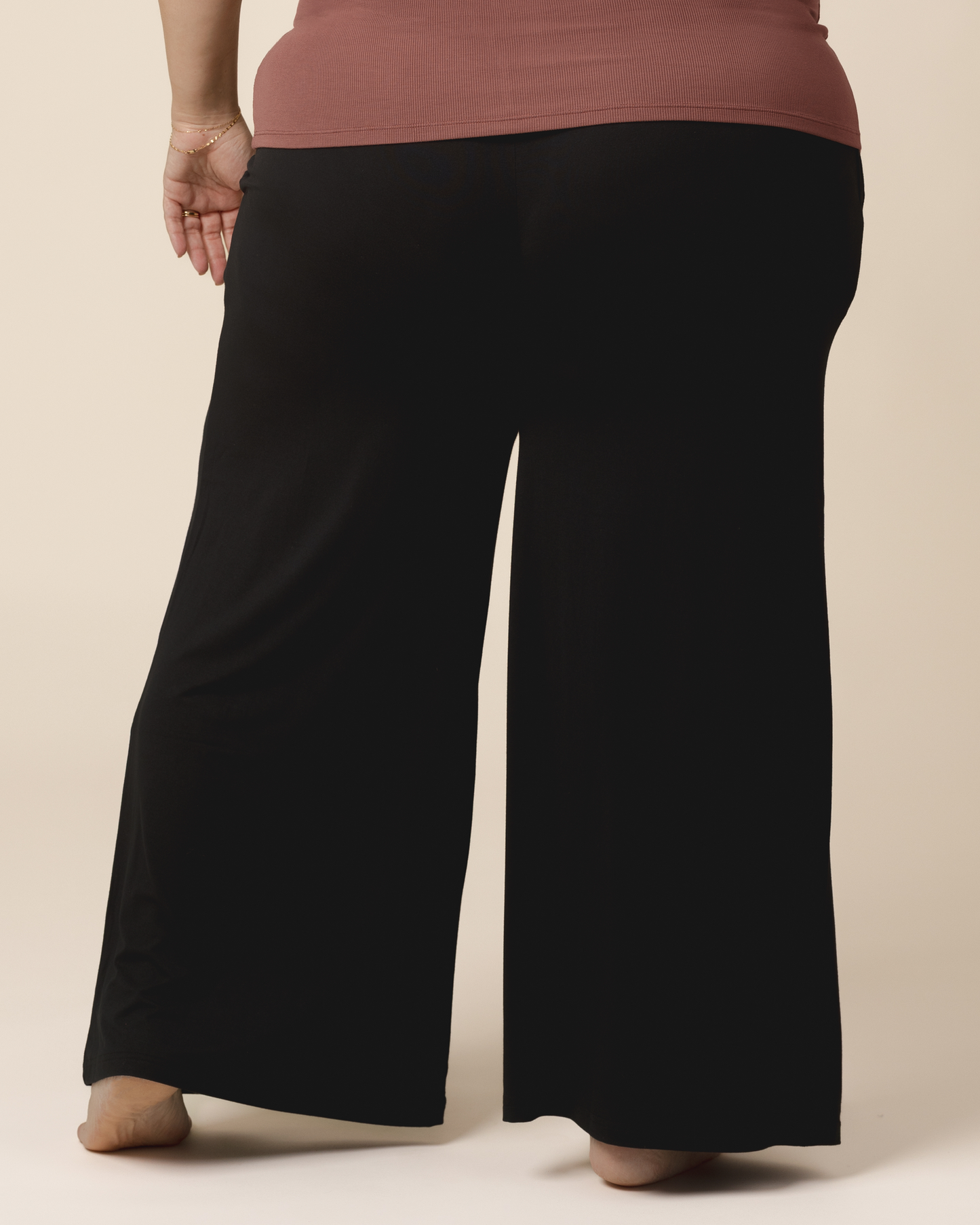 Cropped in back view of model wearing the Bamboo Wide Leg Maternity & Postpartum Lounge Pant in Black. 