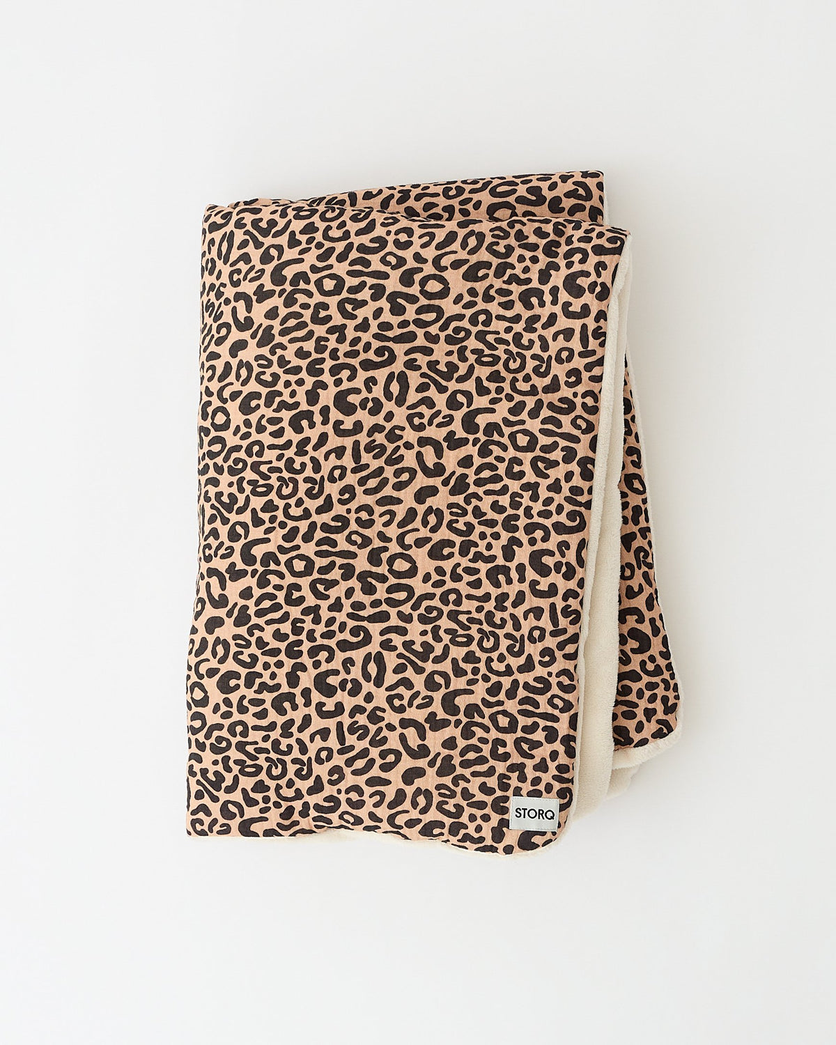Cozy Stroller Blanket in Leopard folded on an off white background.