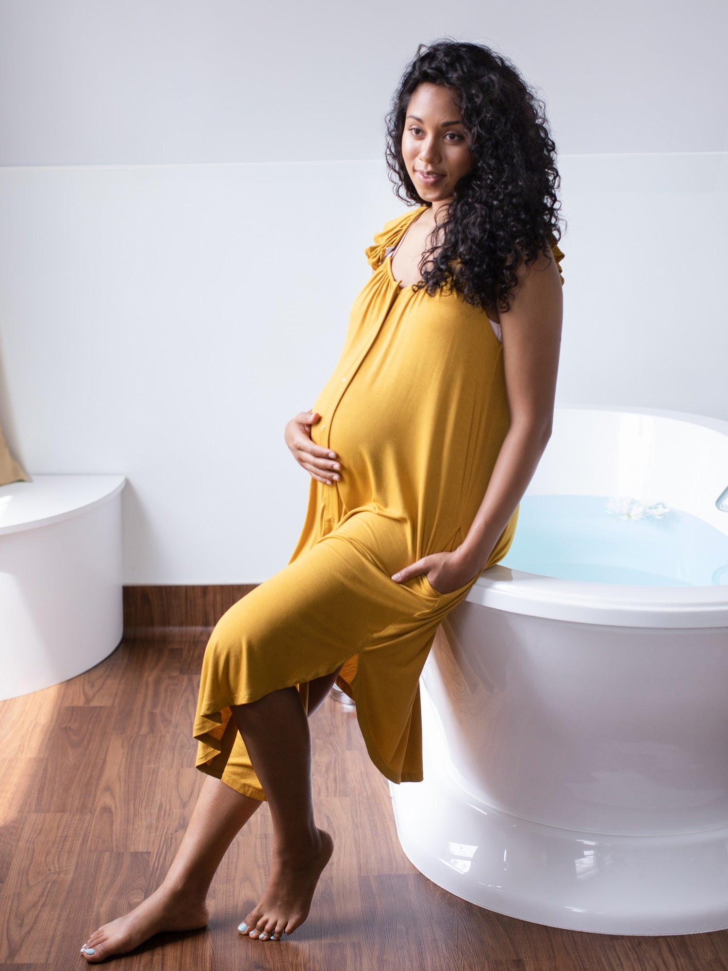 Pregnant Model wearing the Ruffle Strap Labor & Delivery Gown in Honey