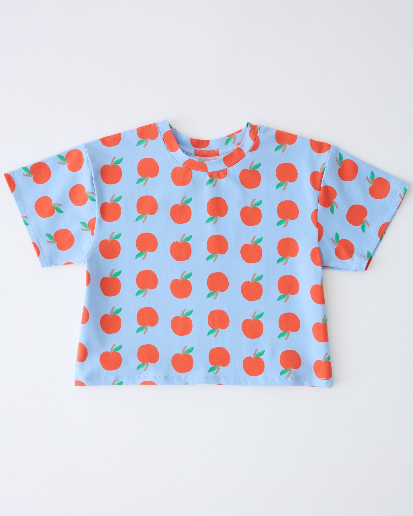 Graphic Tee in Blue Apple on a gray background.