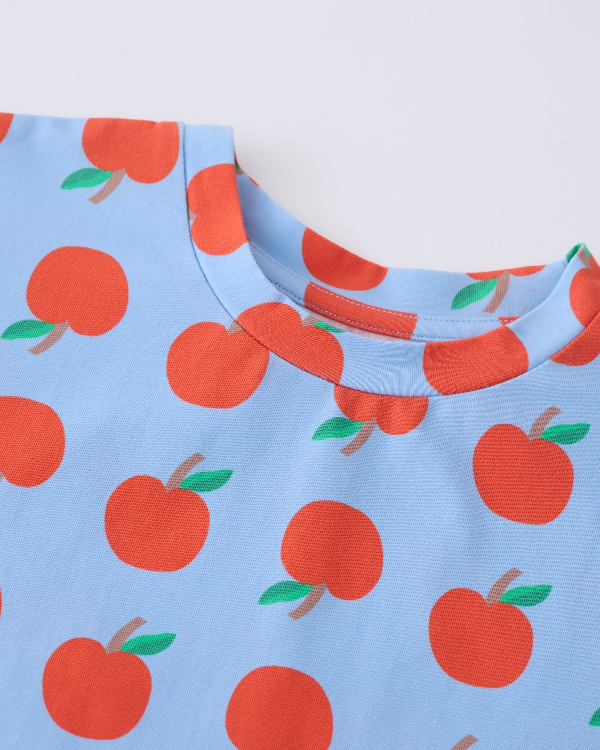 Close up of collar on Graphic Tee in Blue Apple on a gray background.