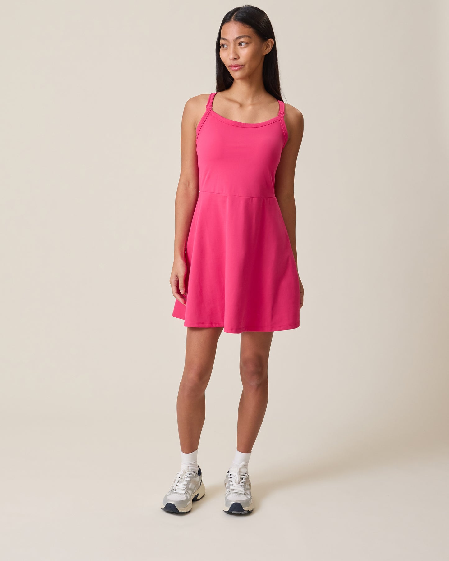 Woman wearing the Stevie Racerback Nursing Dress in Raspberry Pink on a beige background@model_info:Charissa is 5'7" and wearing a Small.
