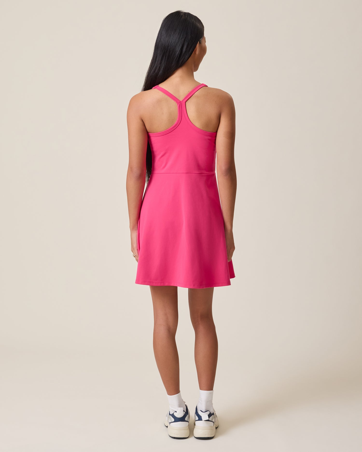 Person wearing the Stevie Racerback Nursing Dress in Raspberry Pink on a plain background