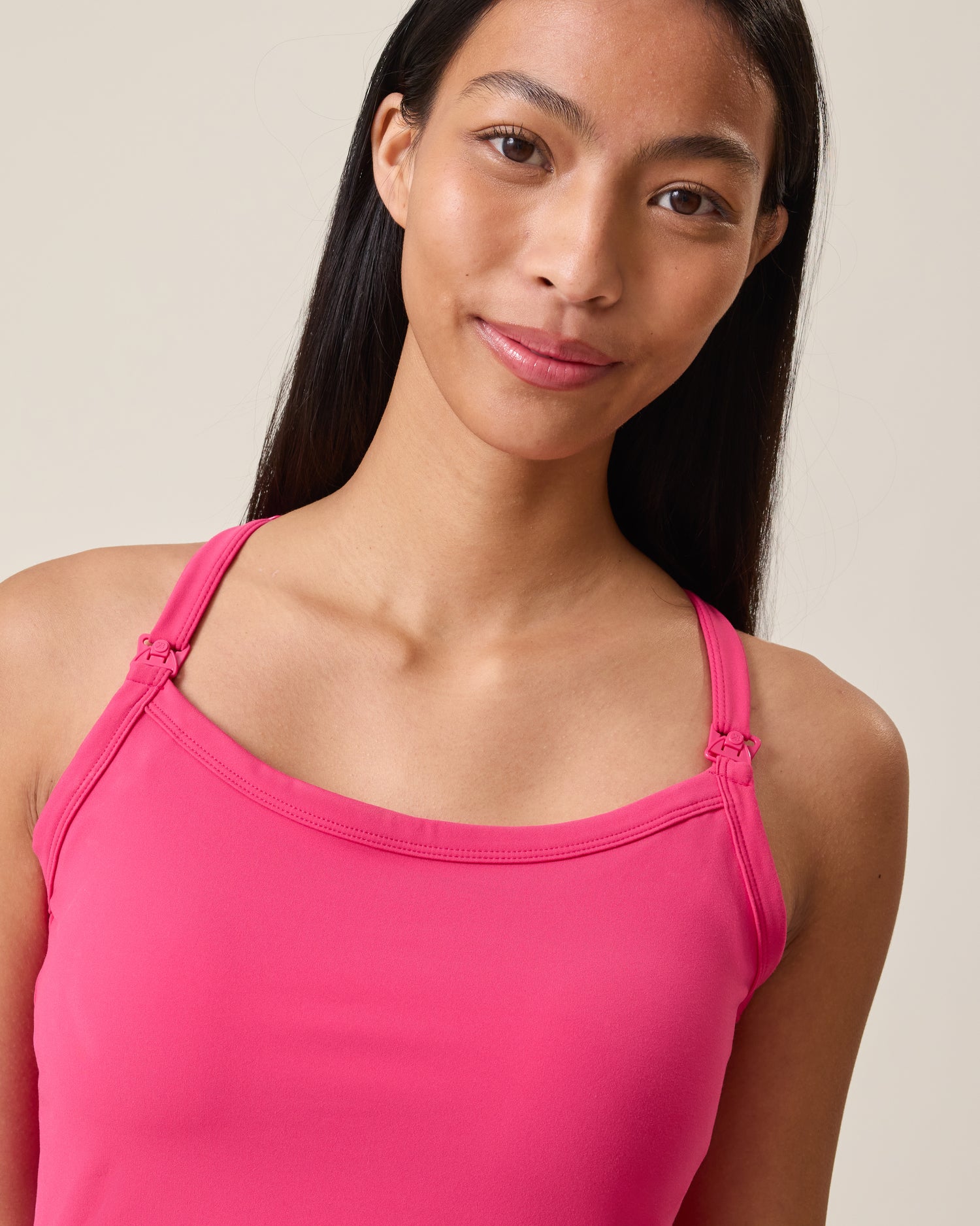 Woman wearing Stevie Racerback Nursing Dress in Raspberry Pink against a neutral background