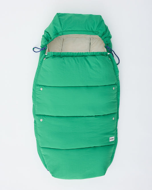 Cozy Stroller Footmuff in Green on an off white background.