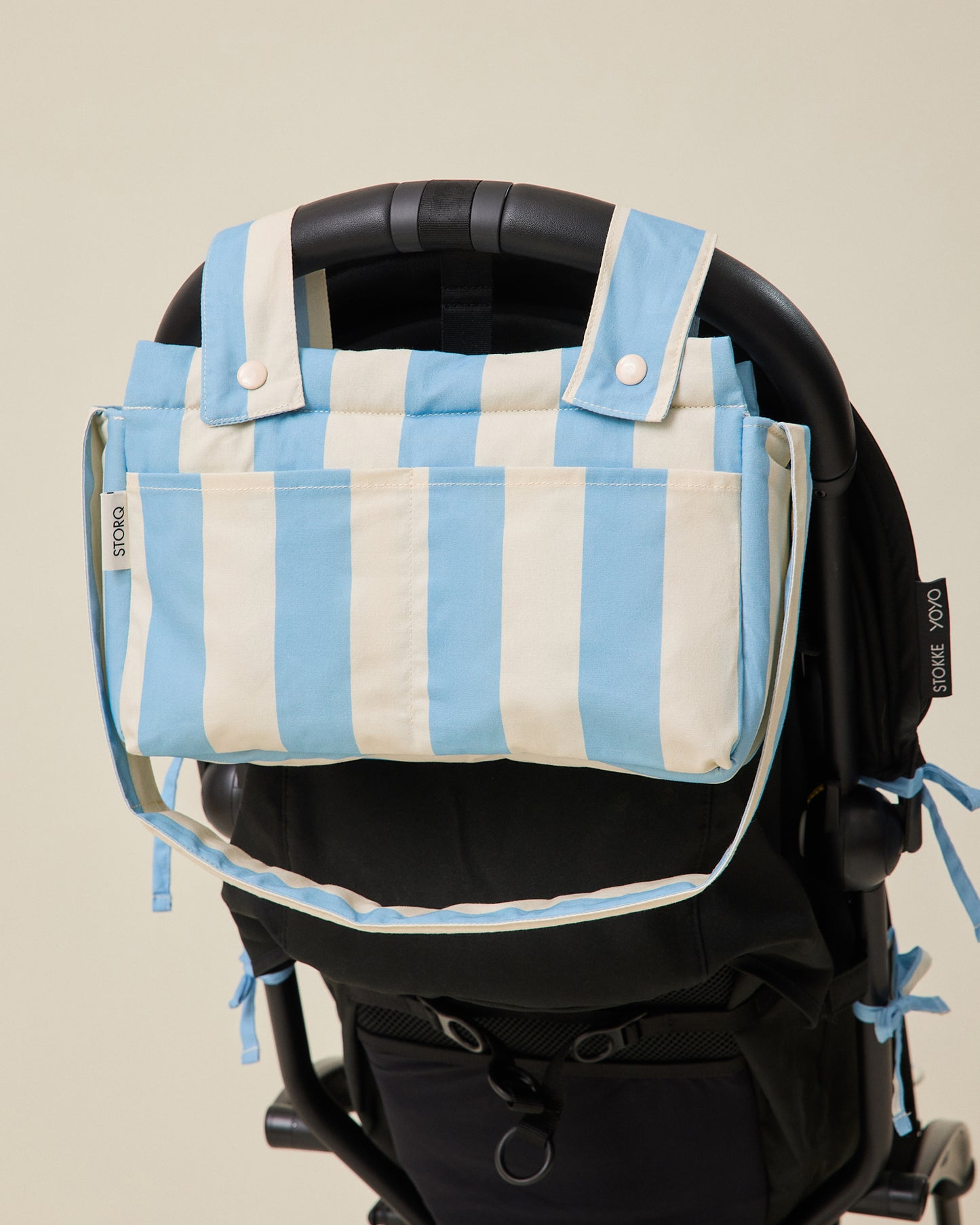 Stroller Party Caddy Bag in Blue Wide Stripe pattern attached to the back of a stroller