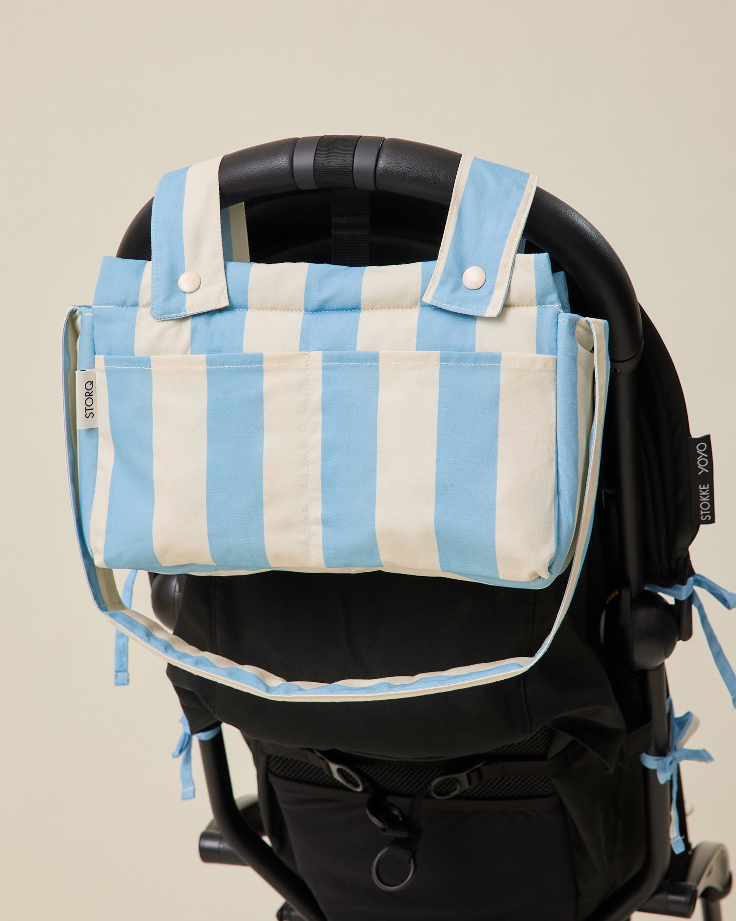 Stroller Party Caddy Bag in Blue Wide Stripe pattern attached to the back of a stroller