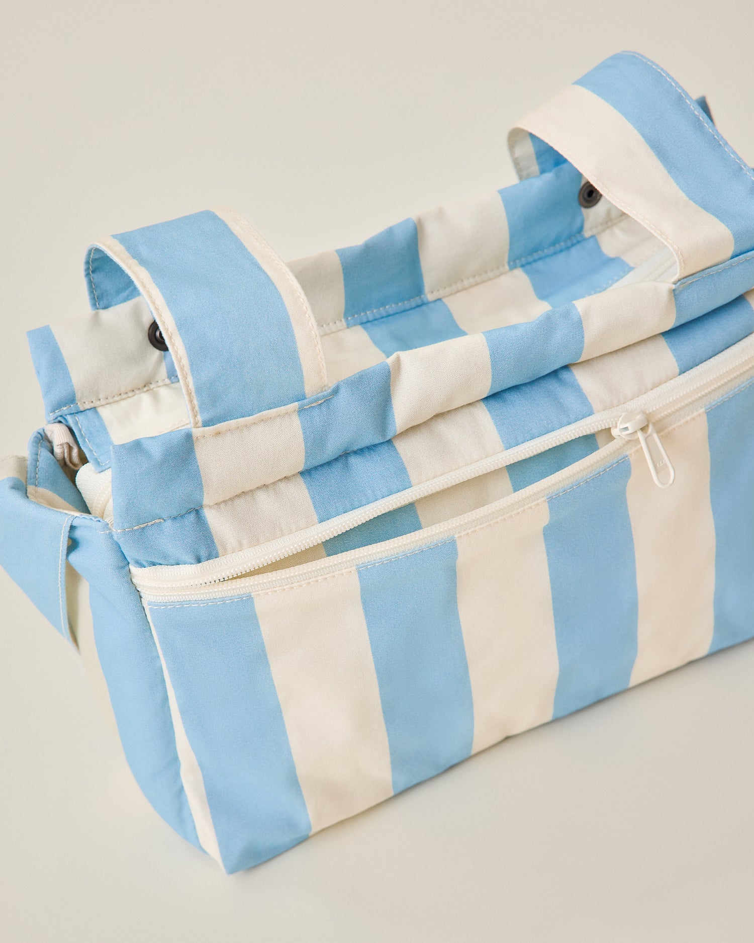 Stroller Party Caddy Bag in Blue Wide Stripe pattern detail view on a beige background