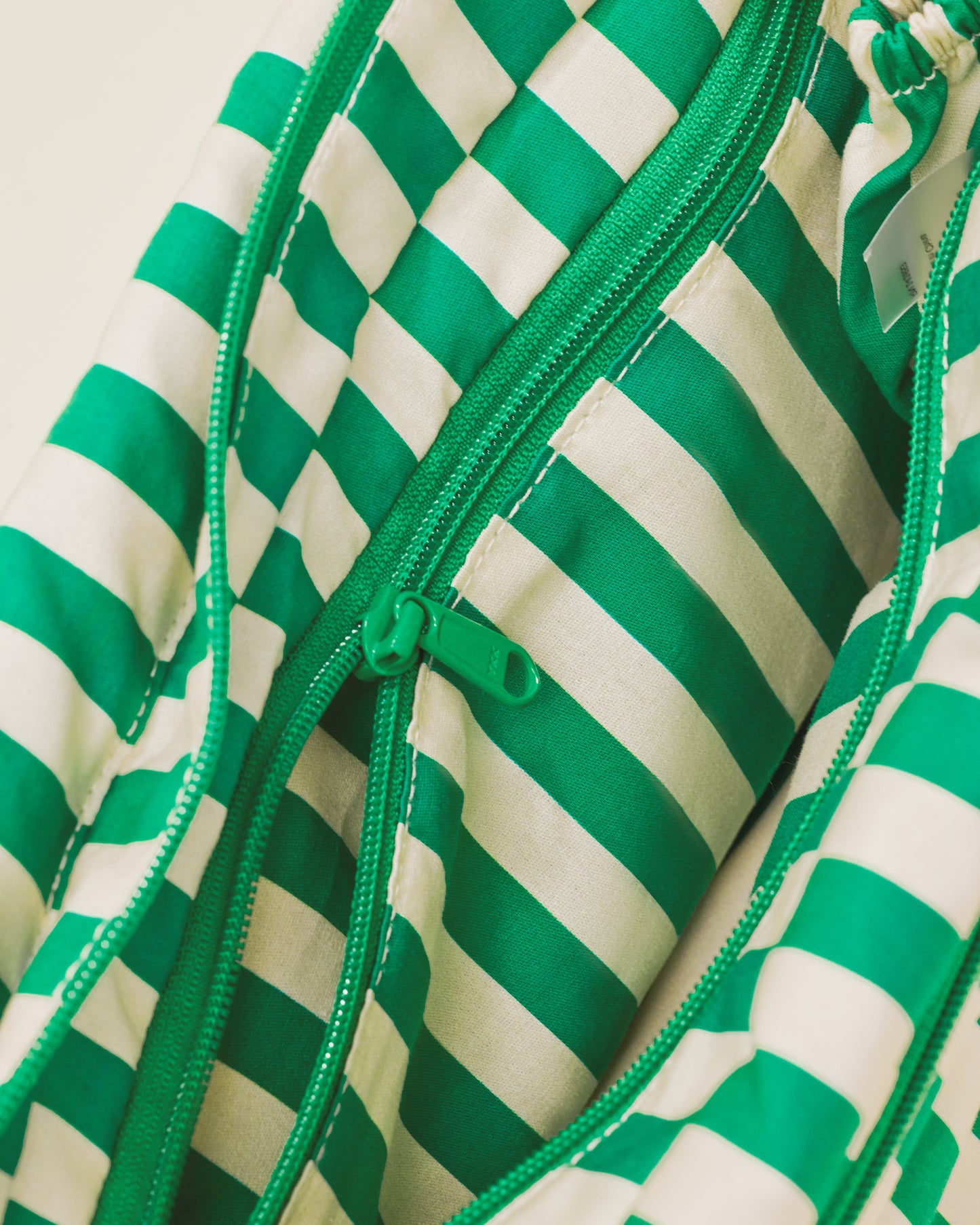 Close up of Stroller Party Caddy Bag in Green Stripe, showing the inside of the bag