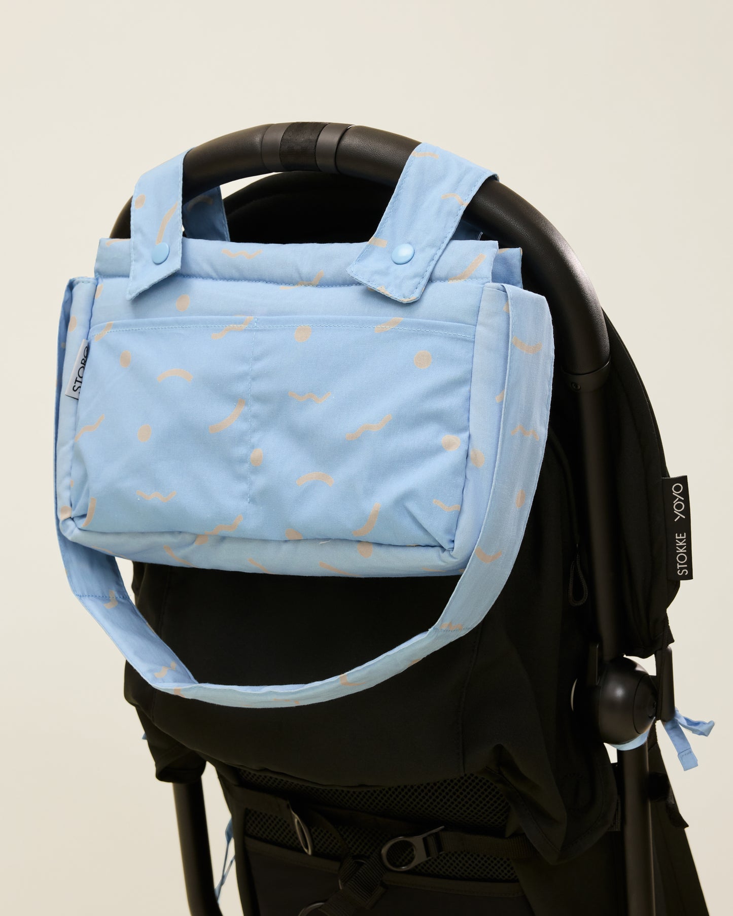 Stroller Party Caddy Bag in Sky Squiggles, attached to the stroller's handle