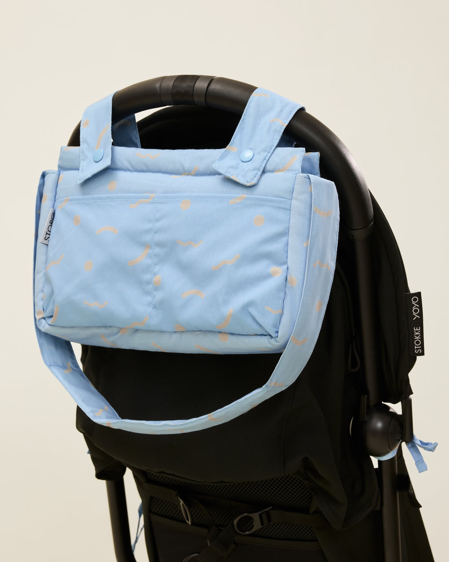 Stroller Party Caddy Bag in Sky Squiggles, attached to the stroller's handle