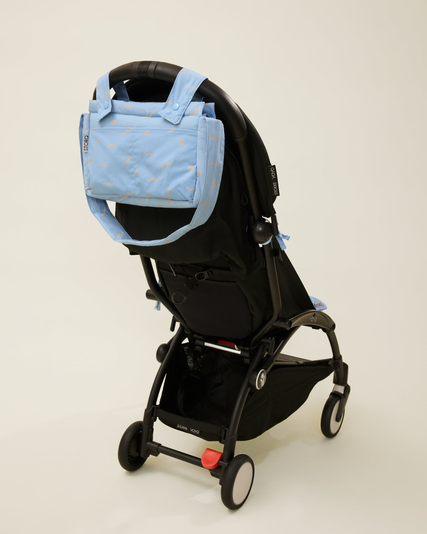 Stroller Party Caddy Bag in Sky Squiggles, attached to the stroller's handle