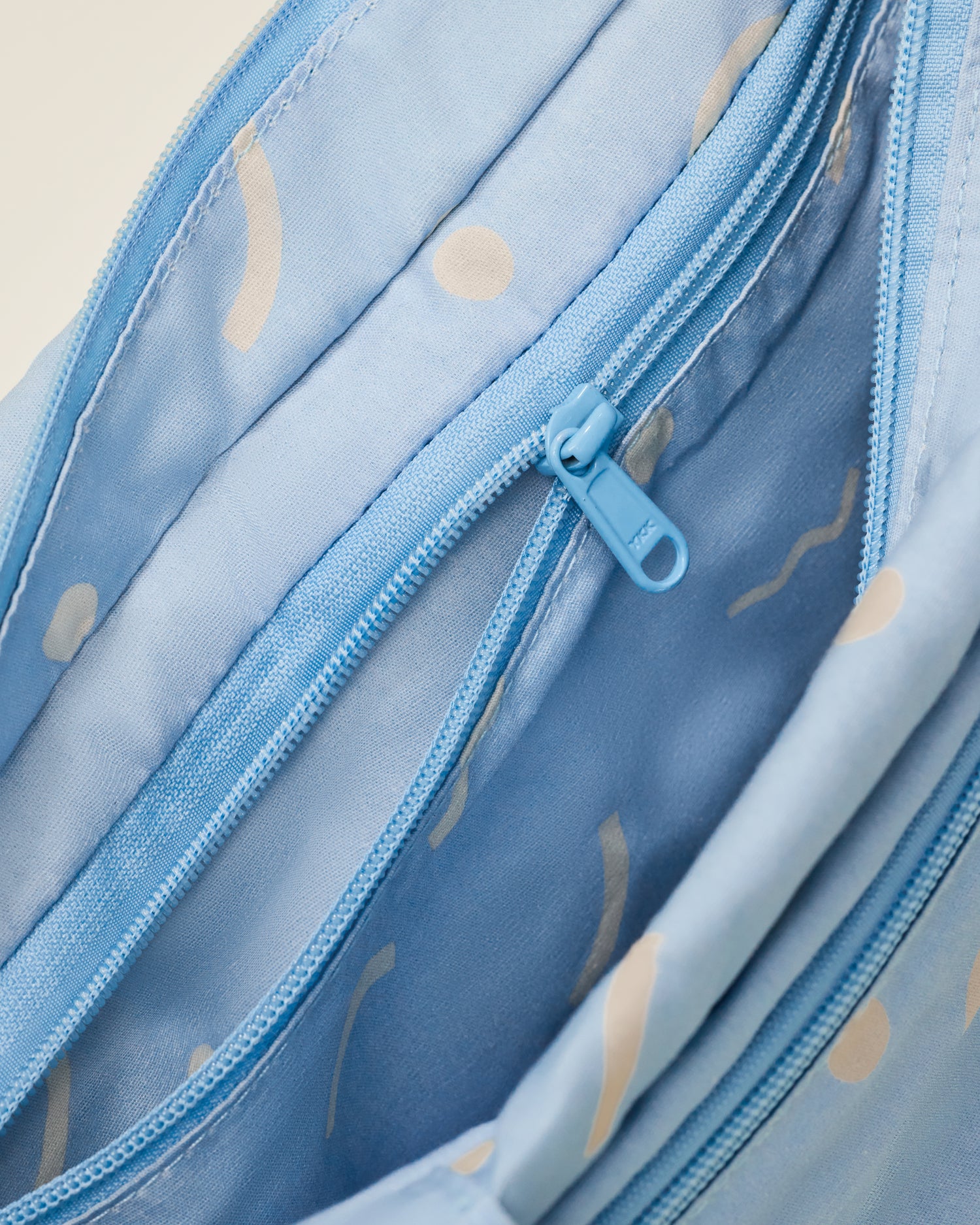 Close up of Stroller Party Caddy Bag in Sky Squiggles, showing the inside of the bag