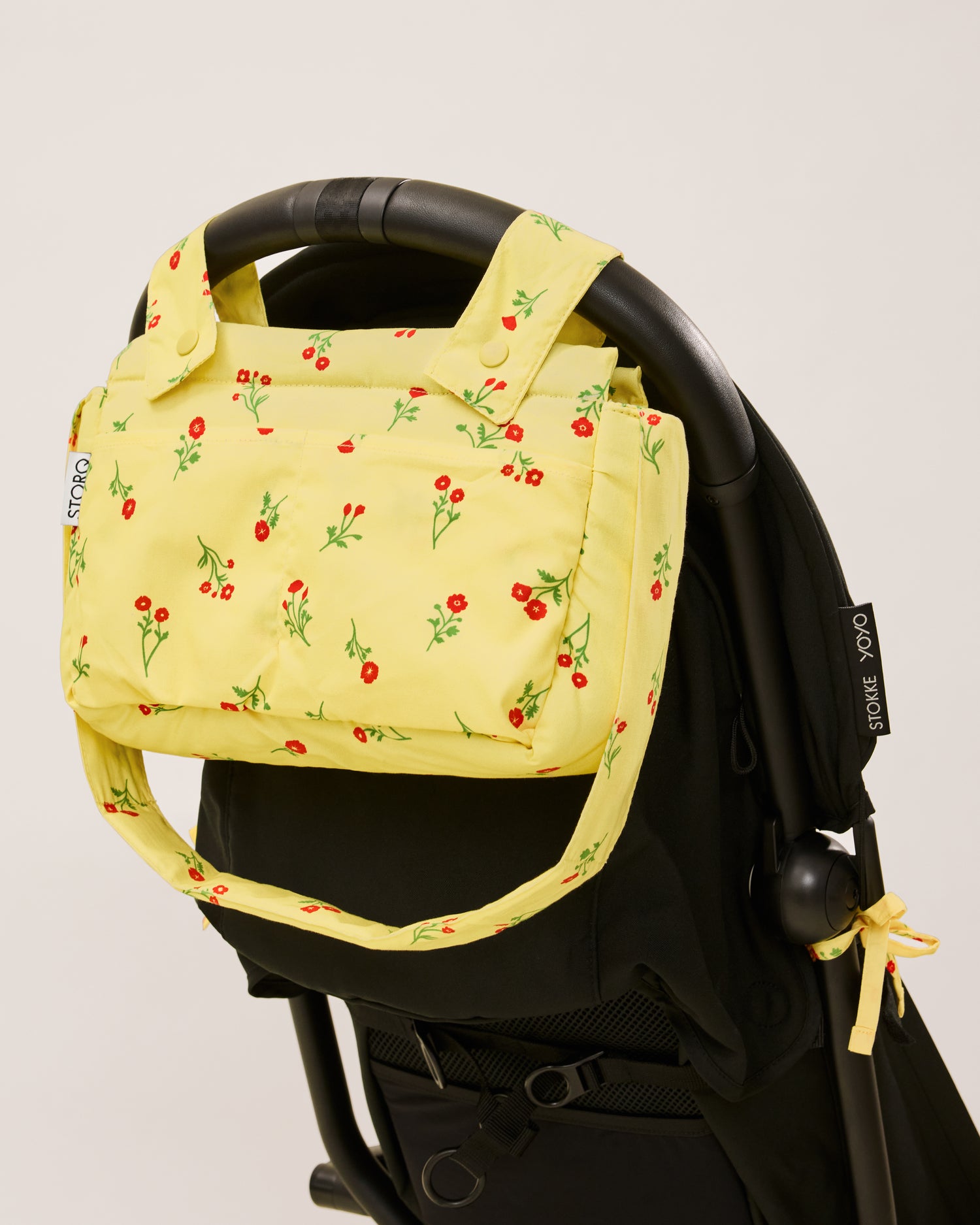 Stroller Party Caddy Bag in Sunshine Wildflower, attached to the stroller's handle