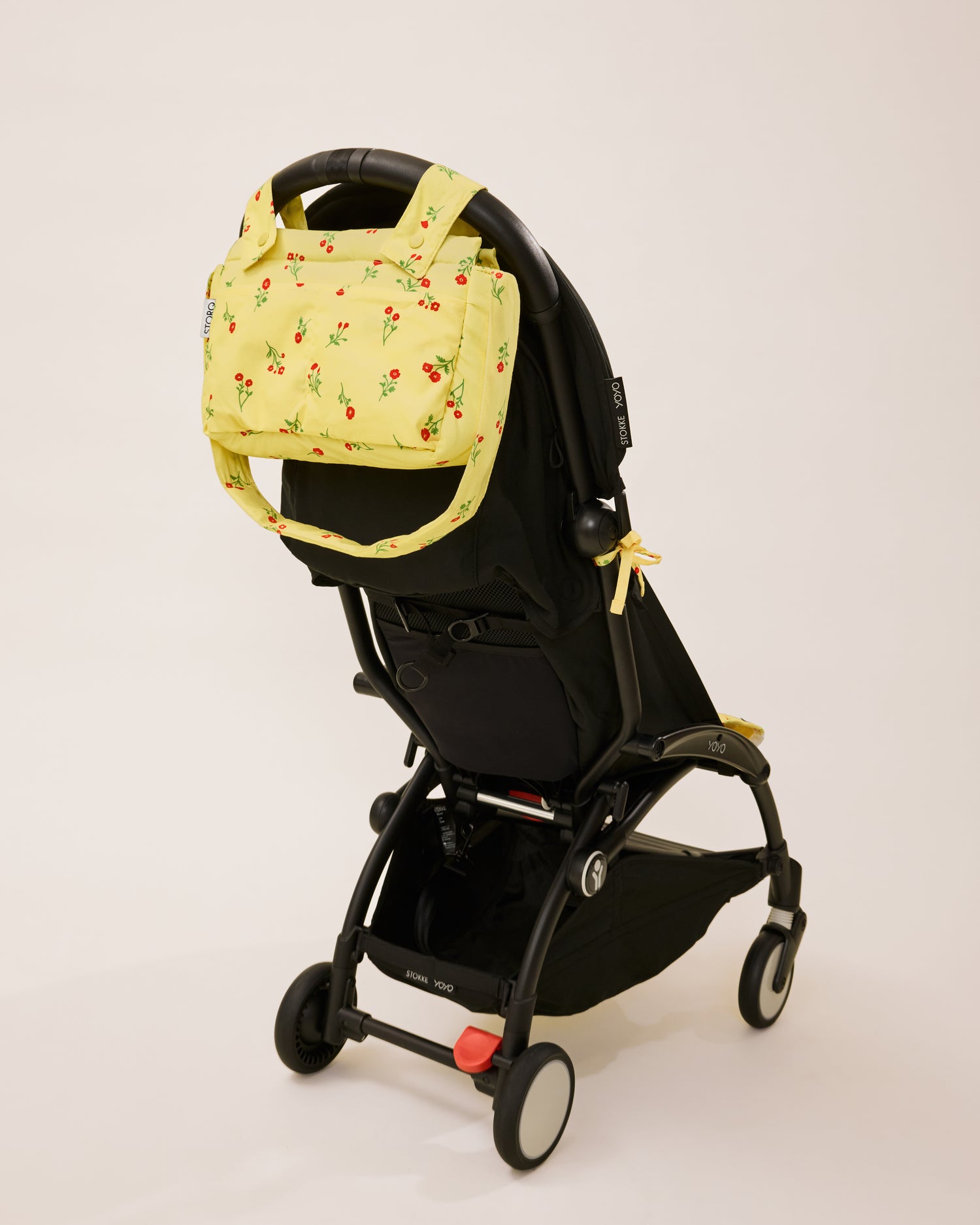 Stroller Party Caddy Bag in Sunshine Wildflower, attached to the stroller's handle