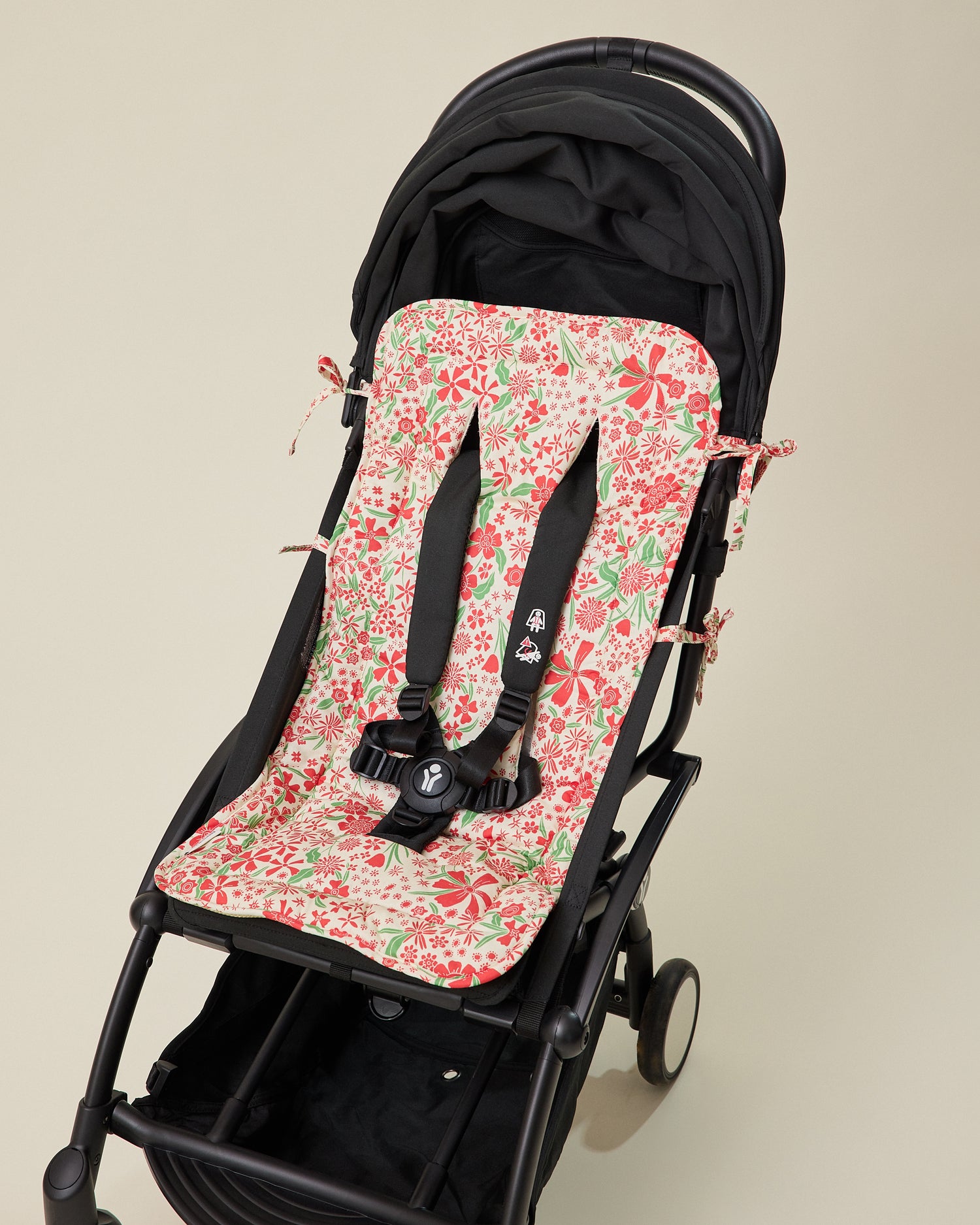 Stroller Party Caddy Seat Liner in Superbloom set in stroller seat on a beige background