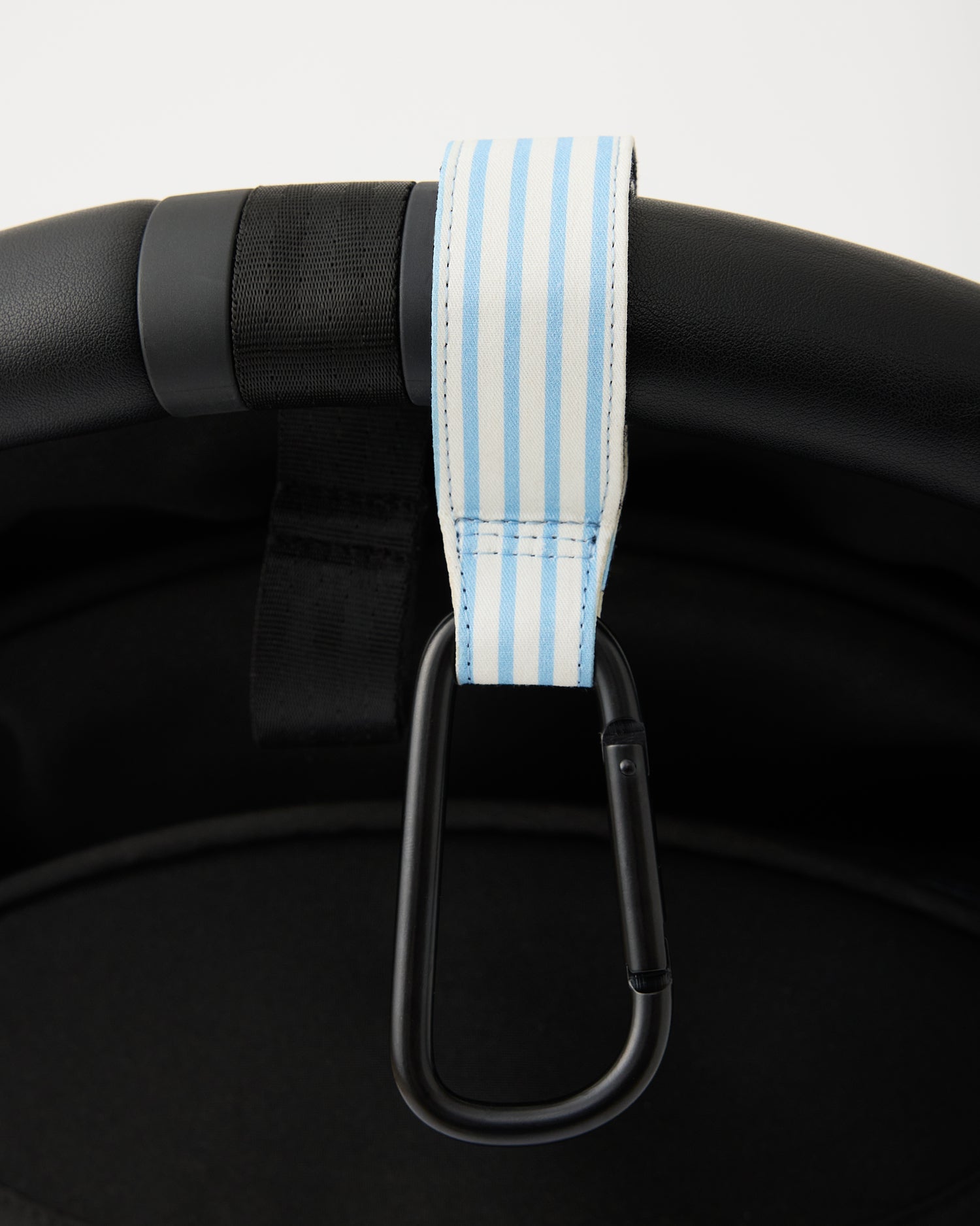 Close up of Stroller Party Clips (2-Pack) in Blue Pinstripe hanging over handlebar of stroller, on a white background.