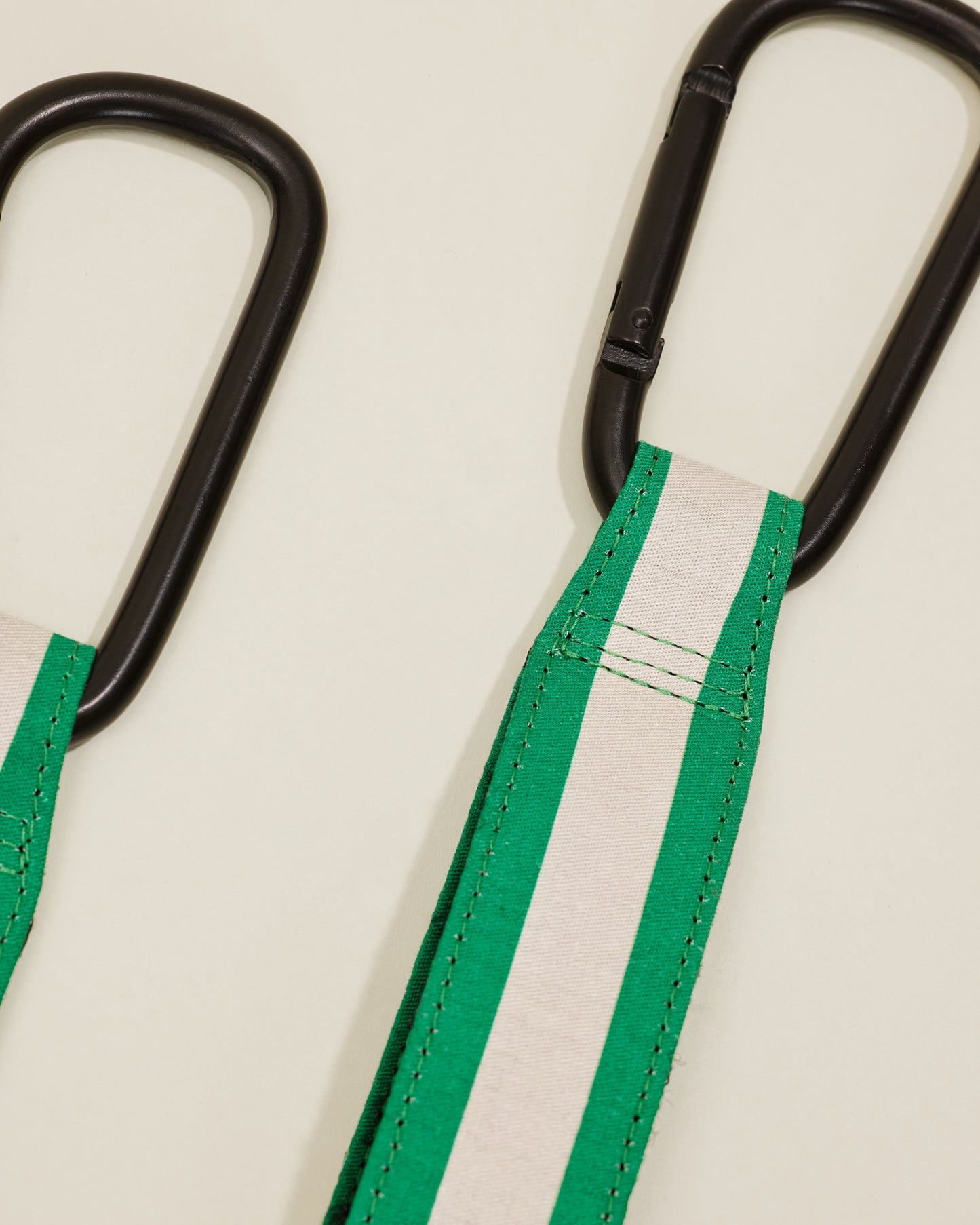Close up of Stroller Party Clips in Green Stripe, on a neutral background