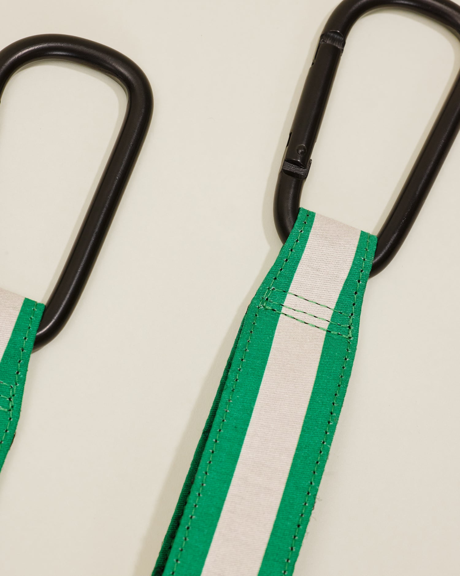 Close up of Stroller Party Clips in Green Stripe, on a neutral background