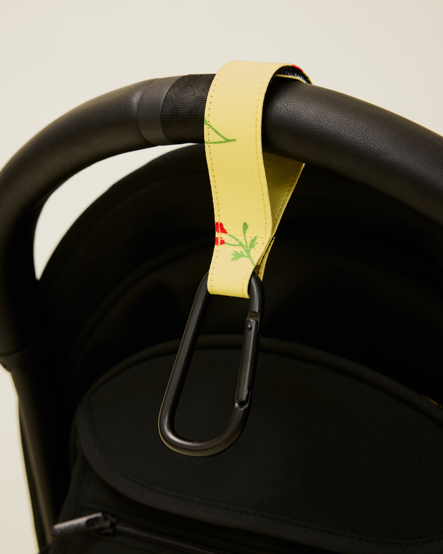 Stroller Party Clips in Sunshine Wildflower attached to a stroller's handle