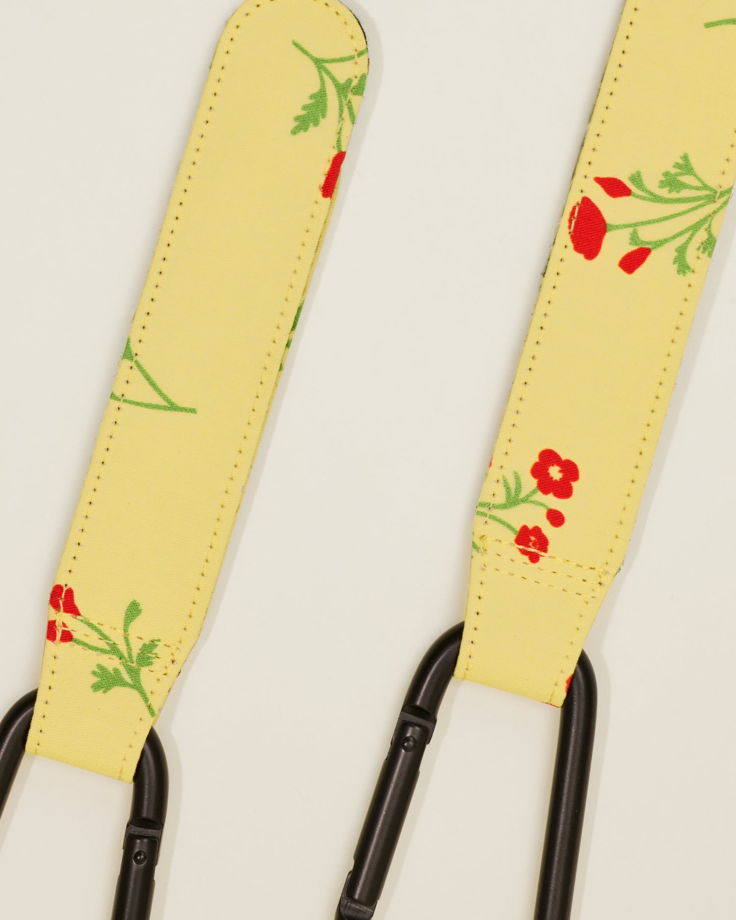 Close up of Stroller Party Clips in Sunshine Wildflower, on a neutral background