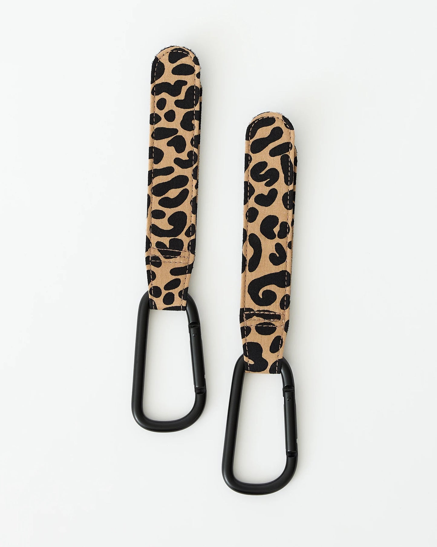 A pair of Stroller Party™ Clips (2-Pack) in Leopard on a beige background.